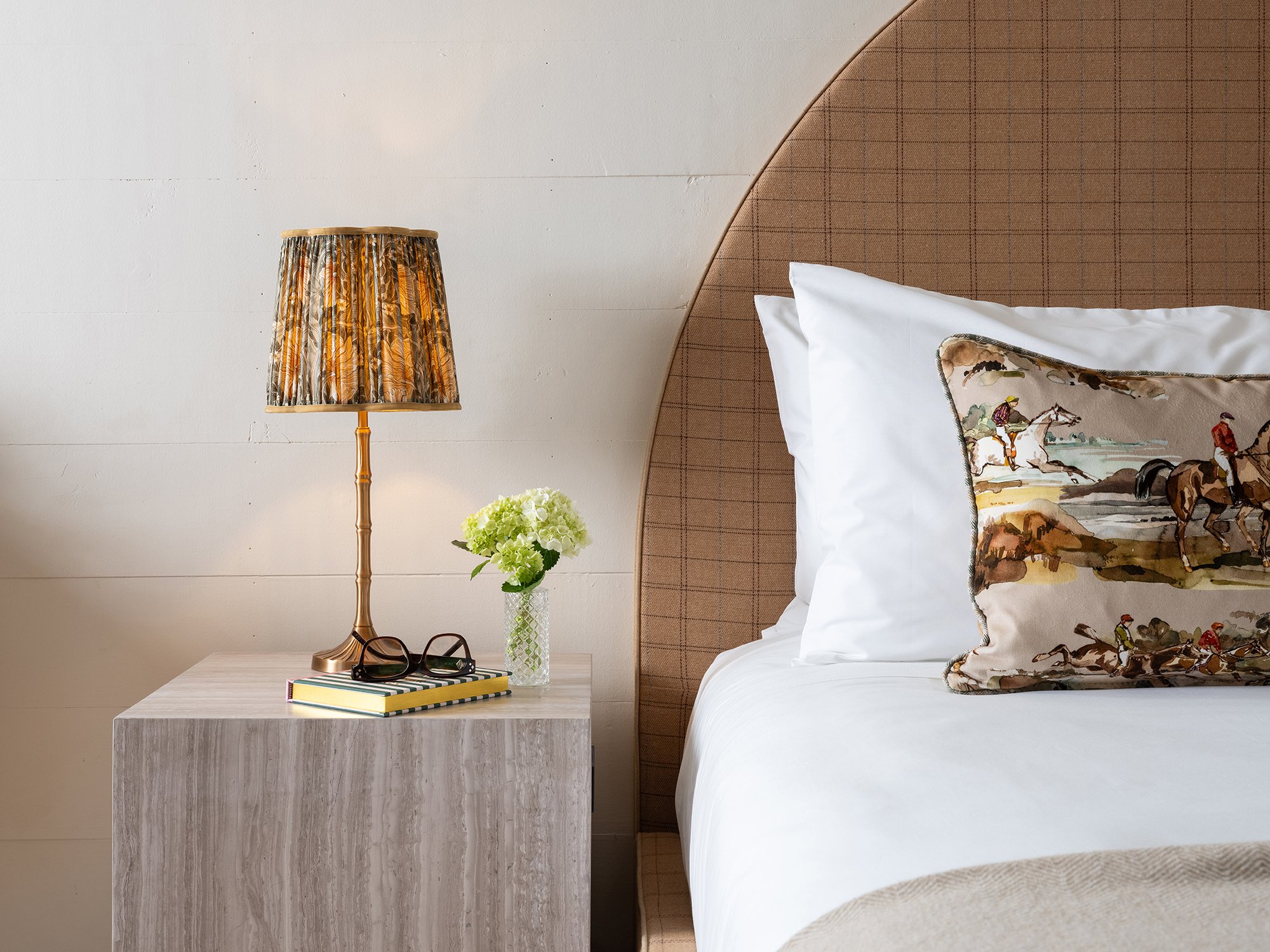 Bedside view of Château Bed with flower vase and glasses on nightstand