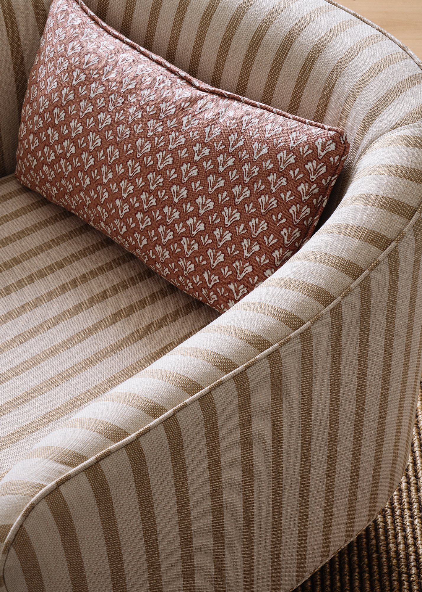 Detail of custom cabana-striped fabric on WOrld Famous Accent Chair with complementary pillow