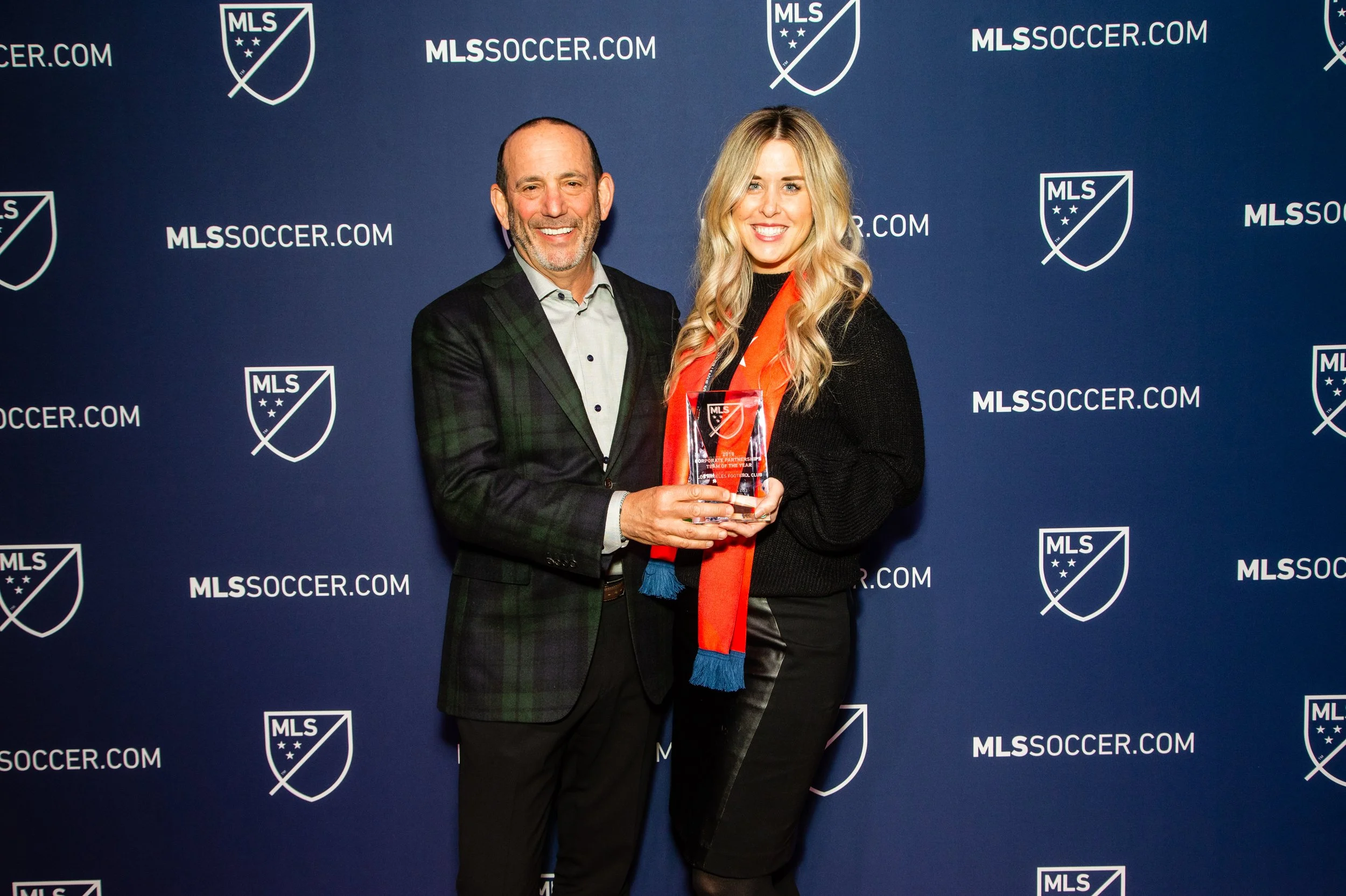 Kristen Kuhn, Don Garber MLS Commissioner award backdrop.