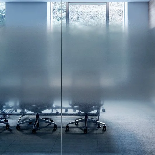 Office chairs behind frosted glass
