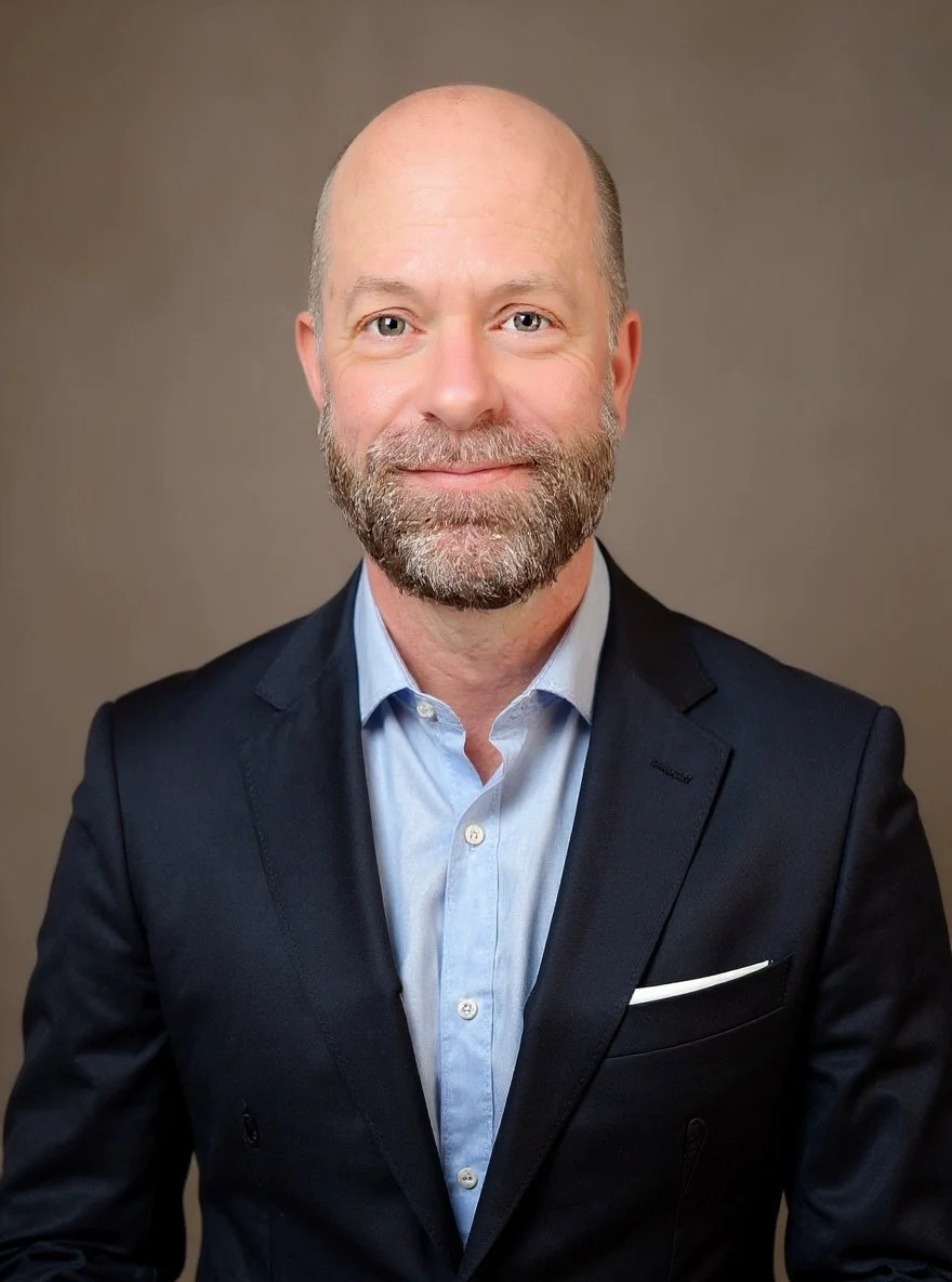 Team member portrait of Viva Energy staff in dark suit with blue shirt
