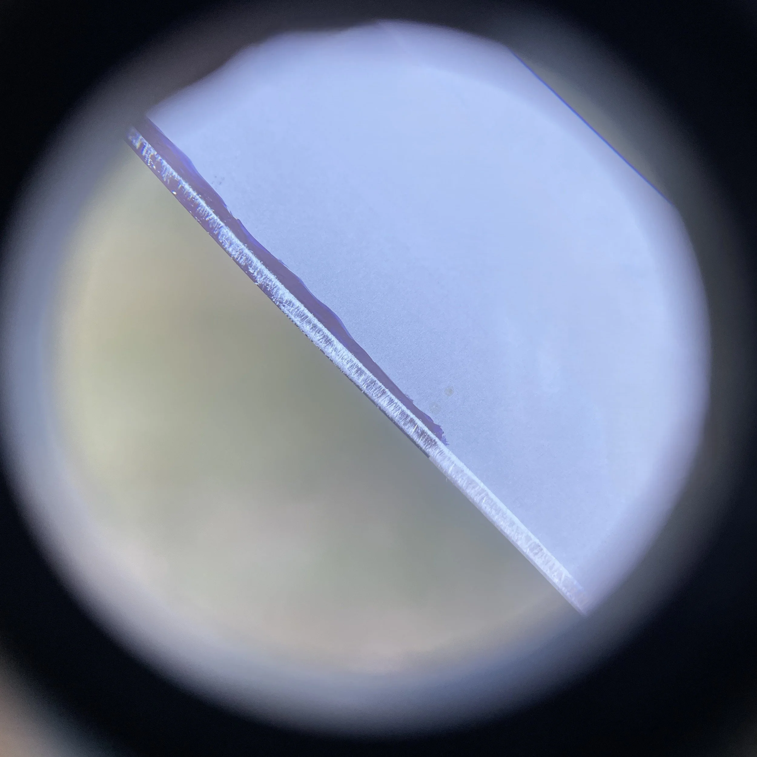 Magnified knife edge showing where permanent marker was worn off after a single sharpening stroke with the knife spine aligned with 5 U.S. pennies which corresponds to about 17 degrees.