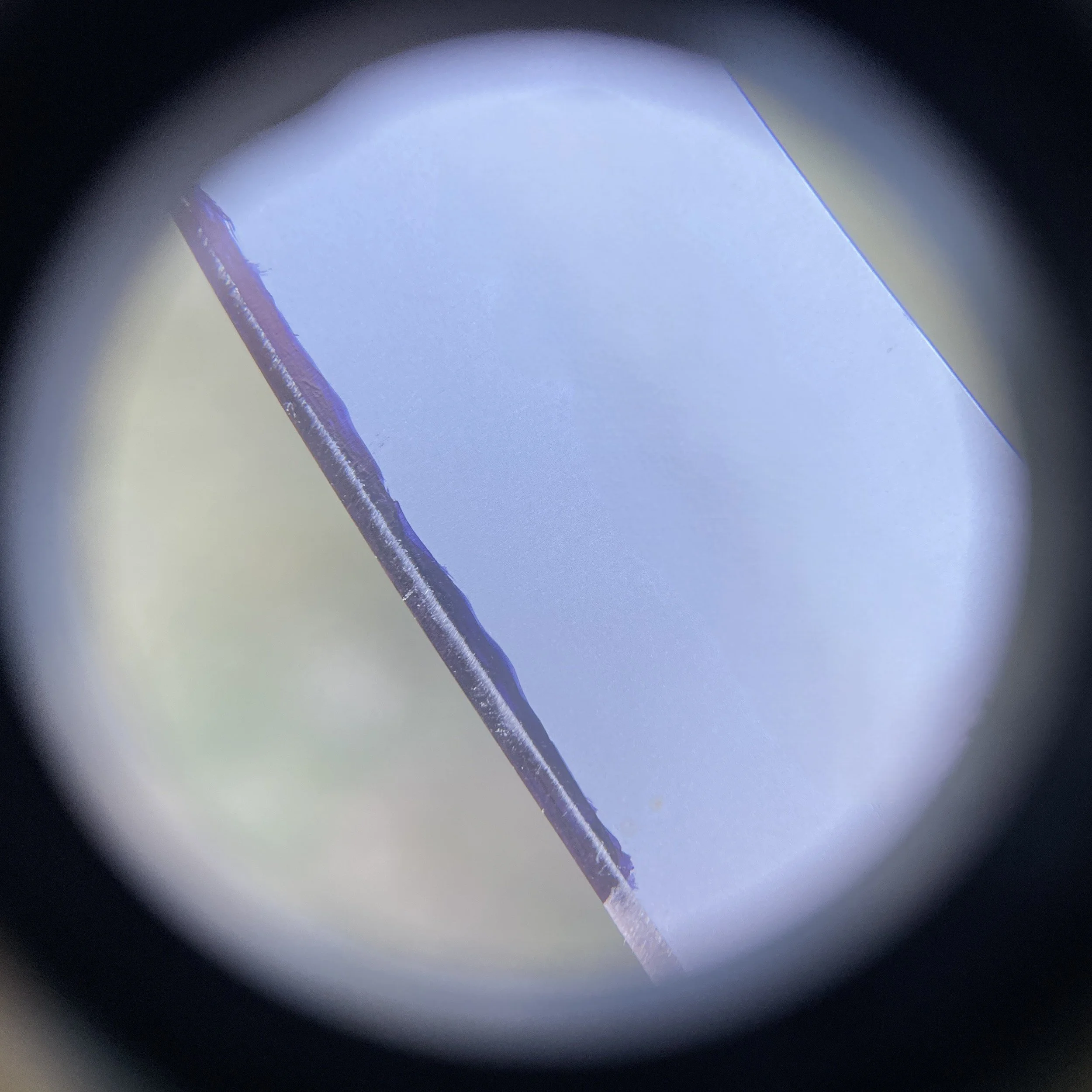 Magnified knife edge showing where permanent marker was worn off after a single sharpening stroke with the knife spine aligned with 3 U.S. pennies which corresponds to 10 degrees.