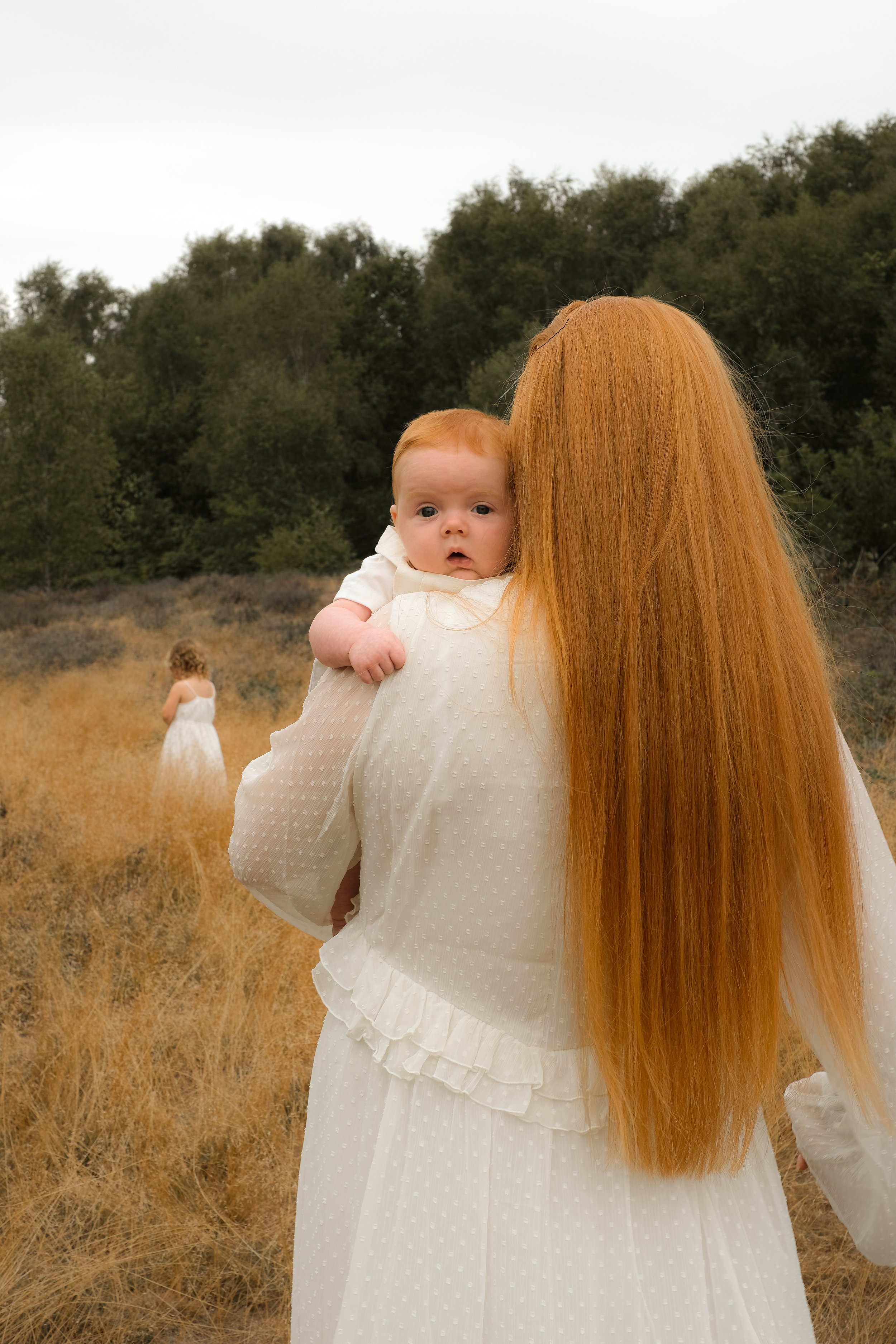 Mother holding newborn during outdoor photoshoot in Bridgnorth Shropshire