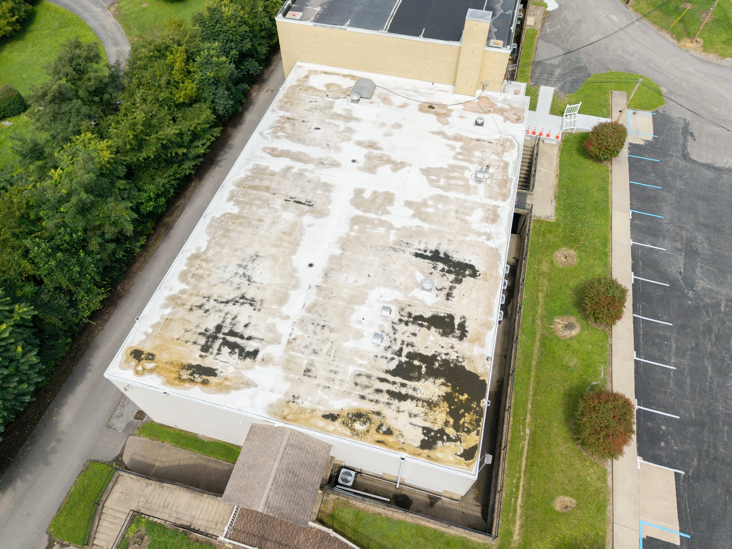  Aerial inspection - Roll roofing inspection image over commercial building with water damage in Morgantown, WV.  