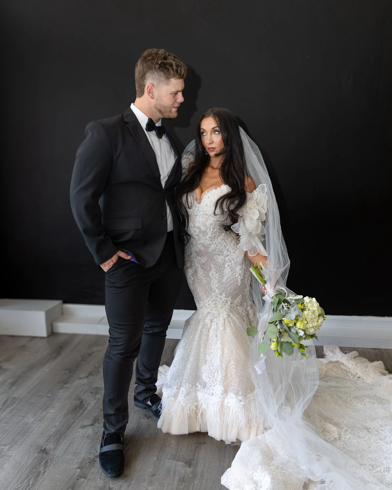 Flash lit studio portrait of bride and groom. 