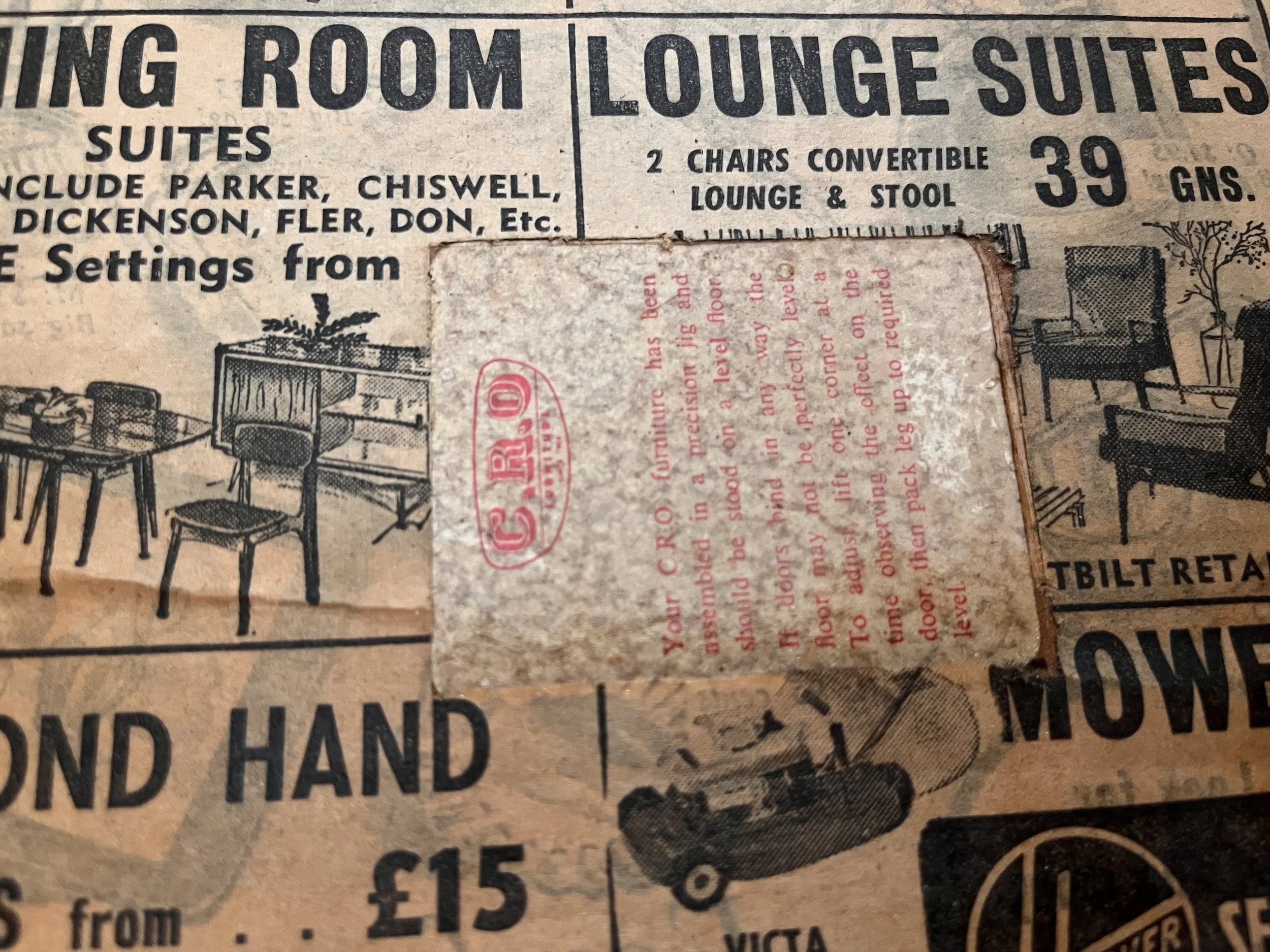Vintage newspaper advertisement for furniture, featuring illustrations of dining room and lounge suites, with prices in pounds and guineas.
