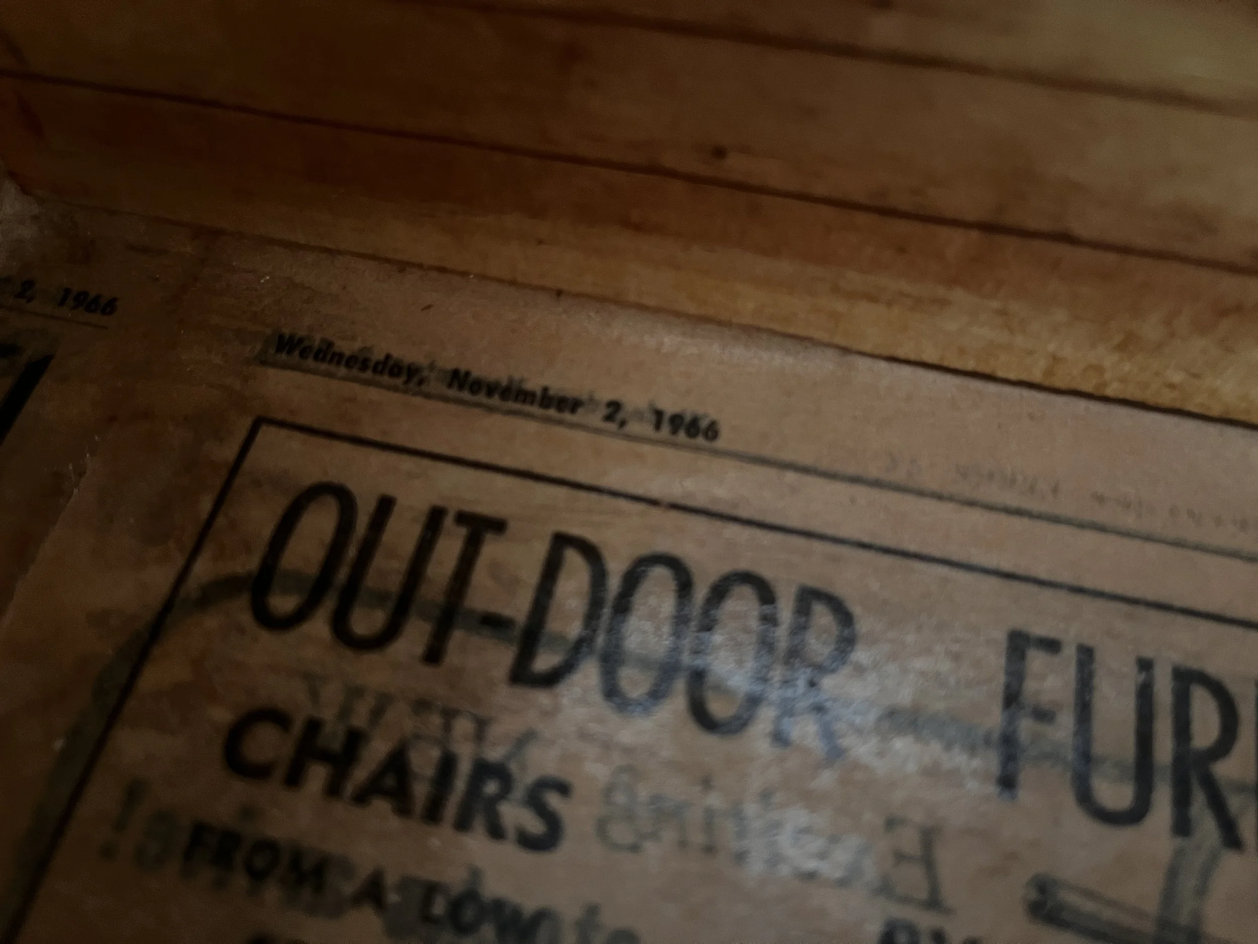Close-up of a vintage newspaper dated Wednesday, November 2, 1966, partially showing a section about outdoor furniture and chairs.