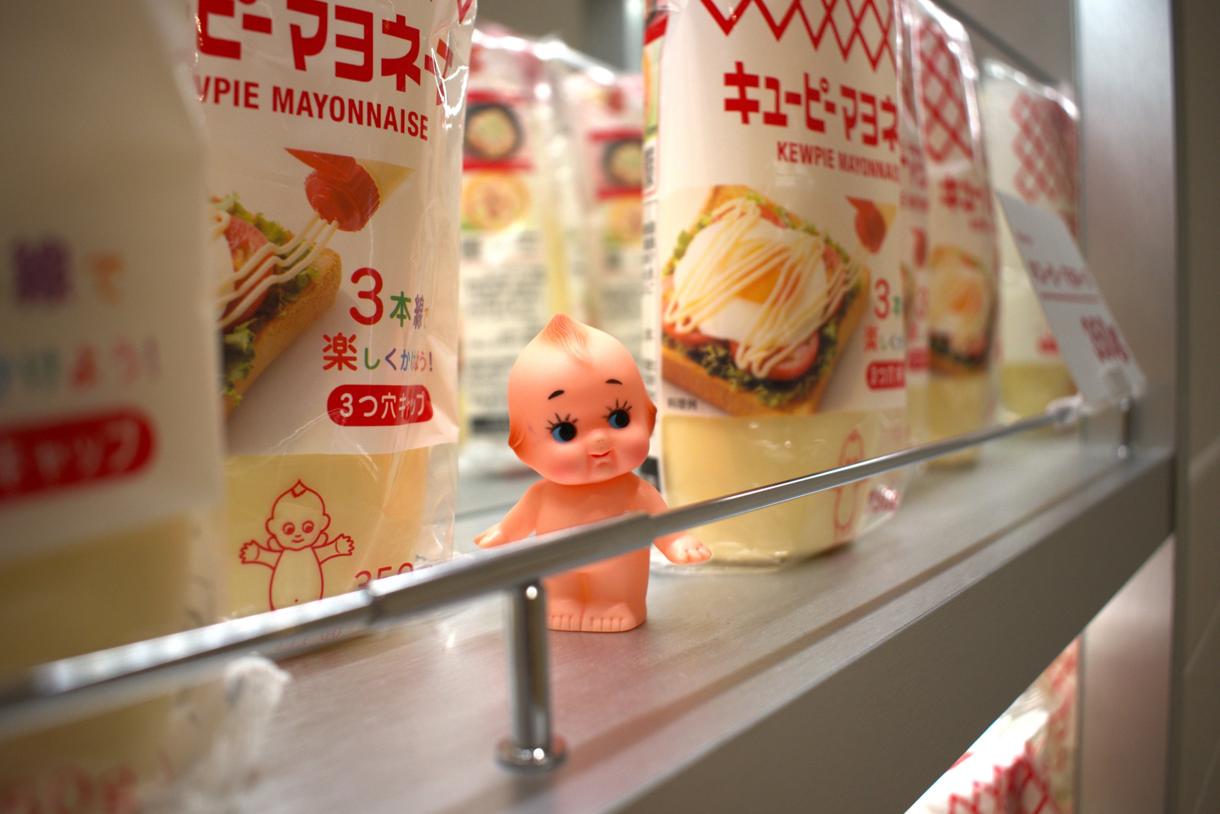 Kewpie Doll in Front of Mayo Bottles, Kewpie Mayo Museum, Japan, 2024: Nikon D3500 24.2MP DSLR