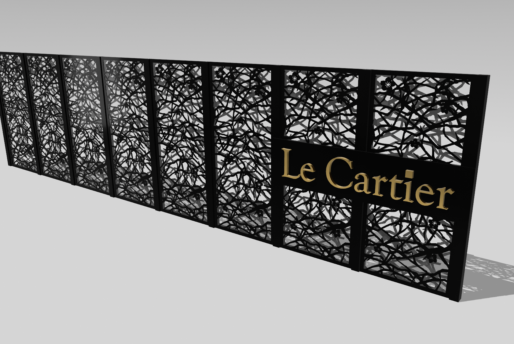 A black metal decorative gate with an intricate vine and floral pattern and a black plaque with gold lettering that reads "Le Cartier."