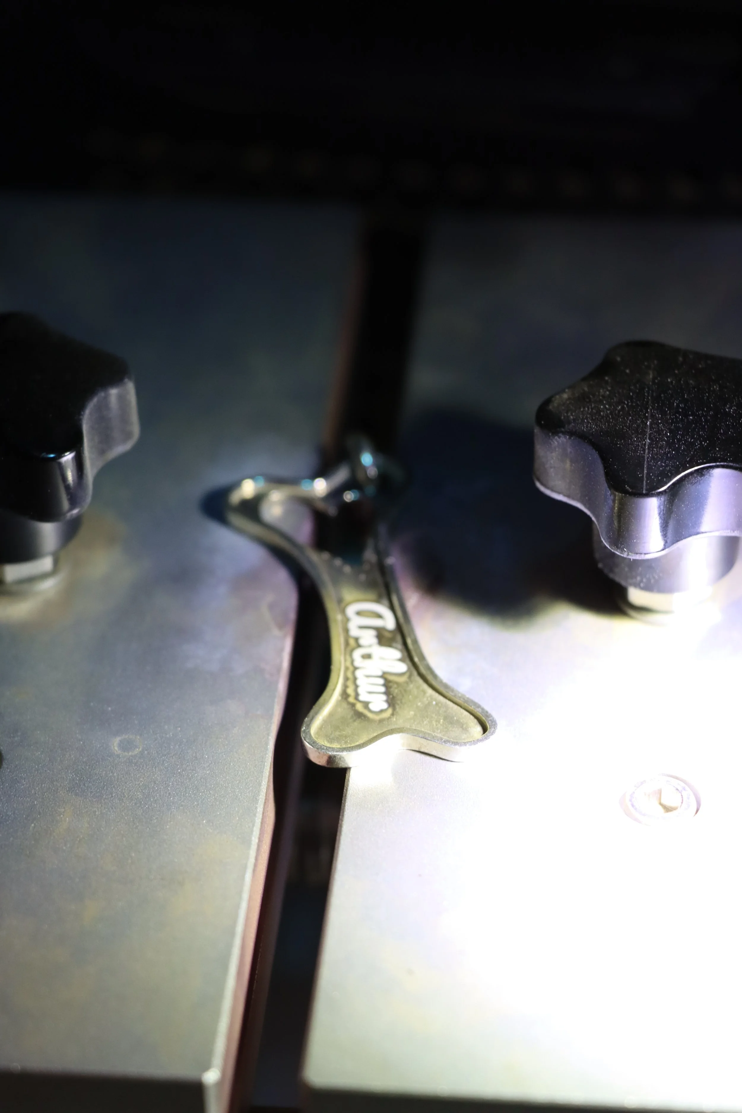 A dog sleeping peacefully on a couch, with its head resting on a person's lap and one paw covering its face. The dog has a brown and black fur coat.