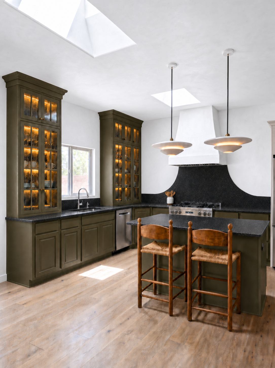 Santa Fe kitchen remodel with olive green cabinetry, black granite counters, and custom plaster range hood by Troy Parker Design