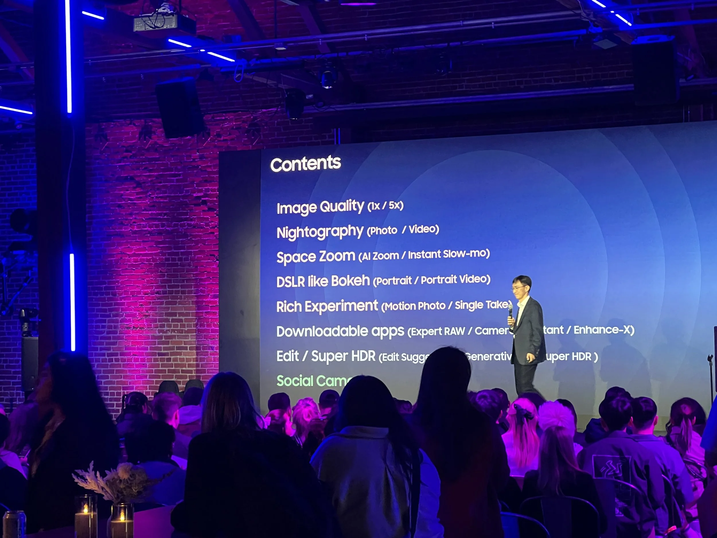 Samsung engineer reviews the technical details of the S24 Galaxy Smartphone during a talk at Samsung Unpacked in 2024 to an audience of influencers.