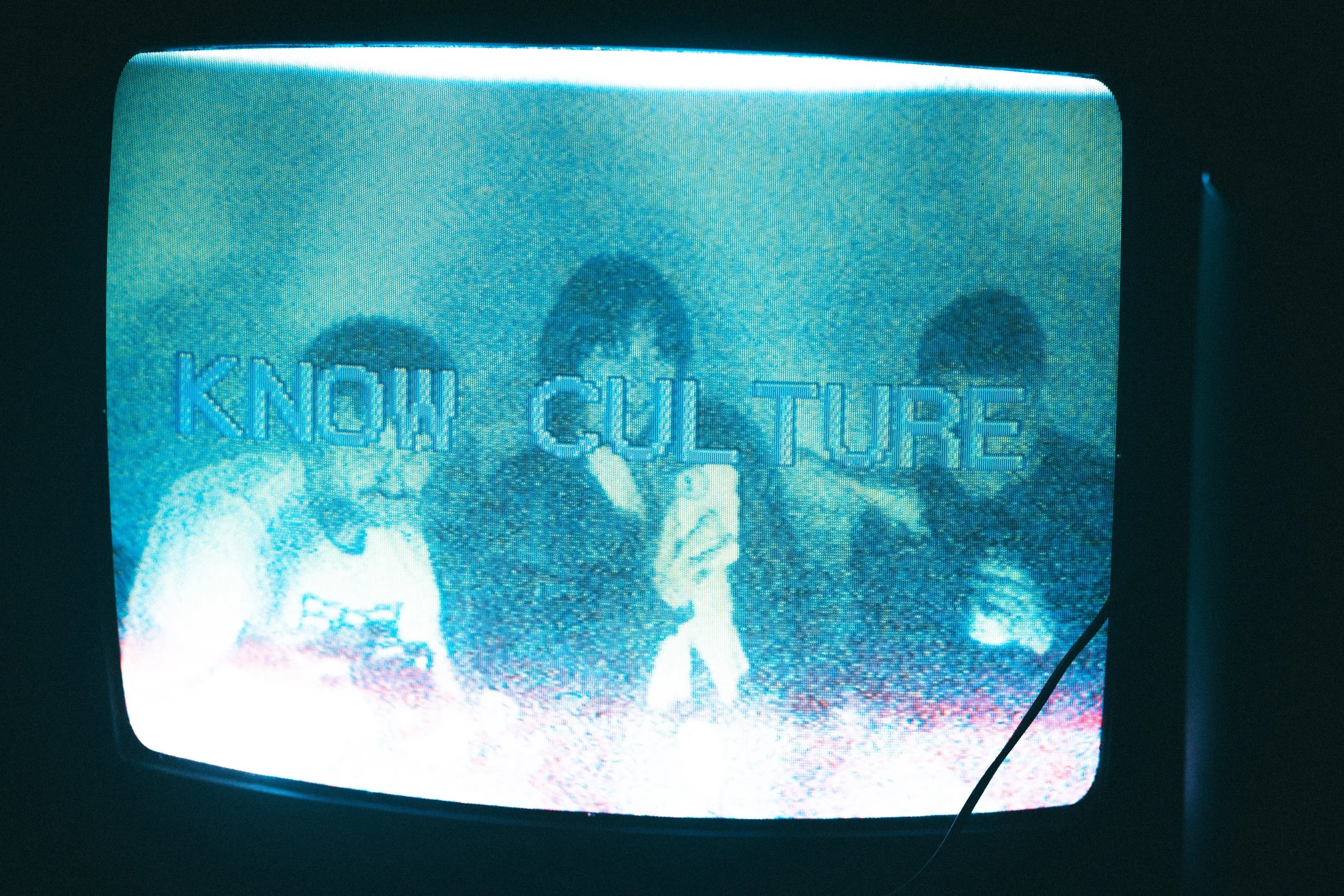 Vintage TV screen displaying distorted image of three people with text 'KNOW CULTURE' overlayed.