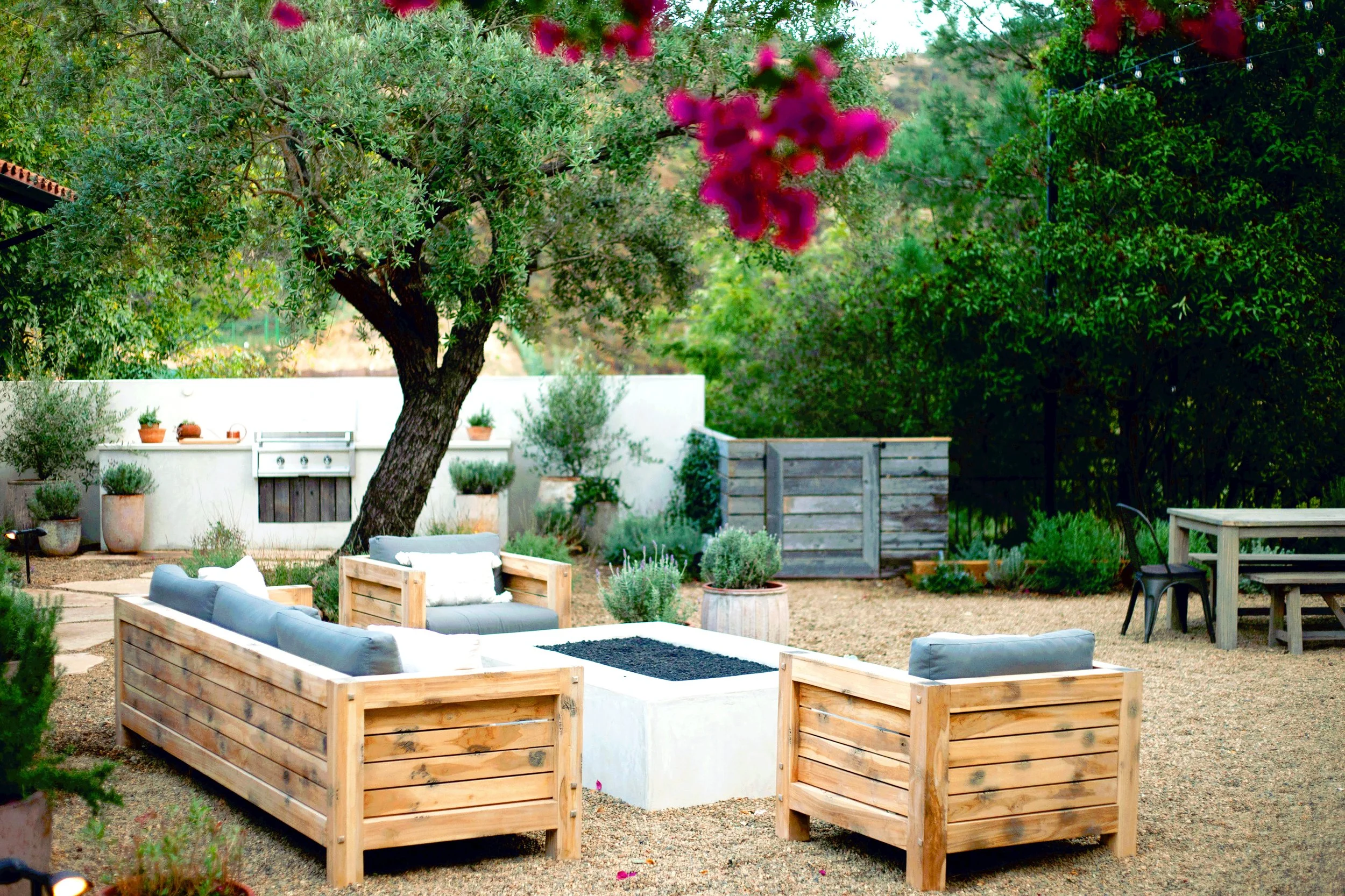 Mountain top rustic property with clean naturalistic feel, reclaimed wood fencing, Spanish elements, layered Mediterranean plantings, Mexican pebbles, and multiple lounge / dining layouts.