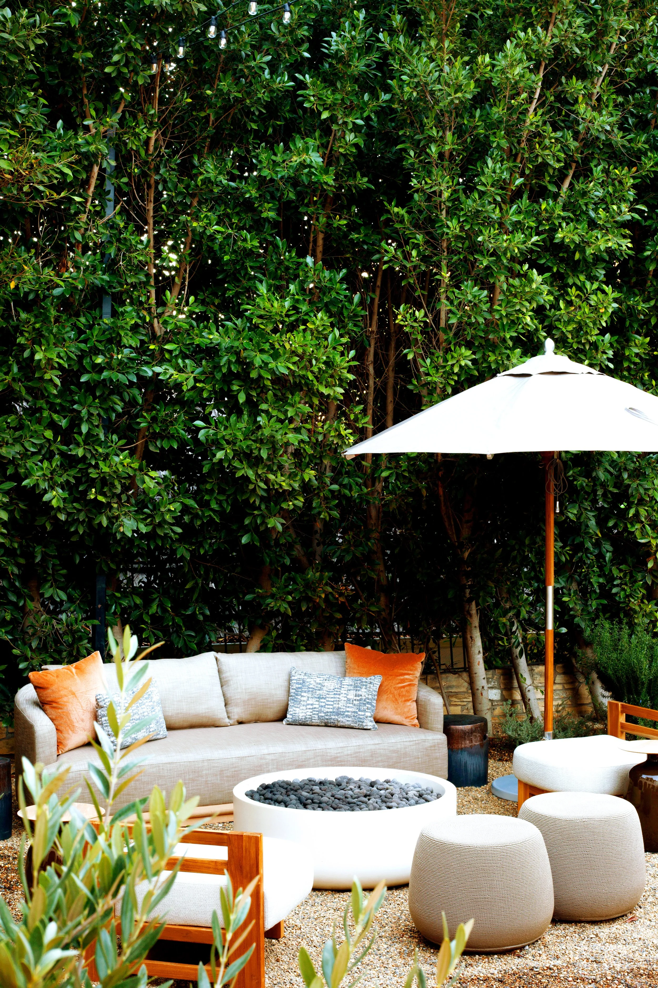 Restored Spanish estate in Hollywood Hills with new vs old terracotta tiles, layers of lush landscaping, lawn space, fire pit lounge, dining and pool.
