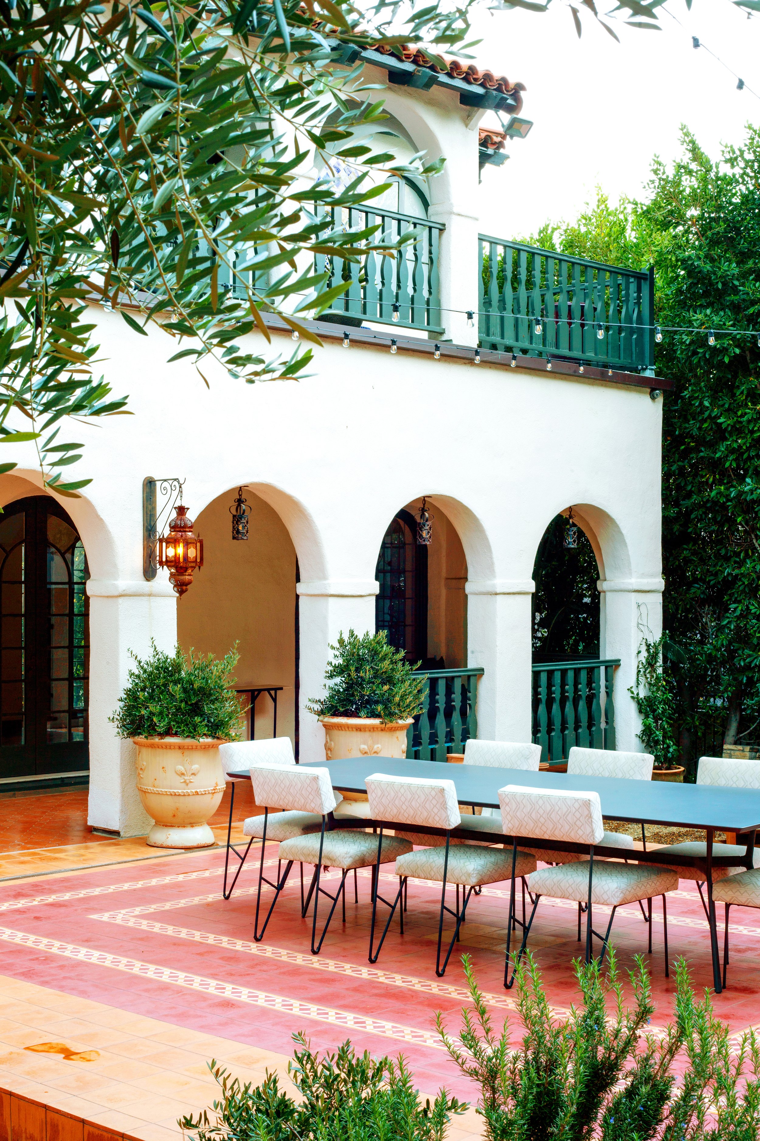 Restored Spanish estate in Hollywood Hills with new vs old terracotta tiles, layers of lush landscaping, lawn space, fire pit lounge, dining and pool.