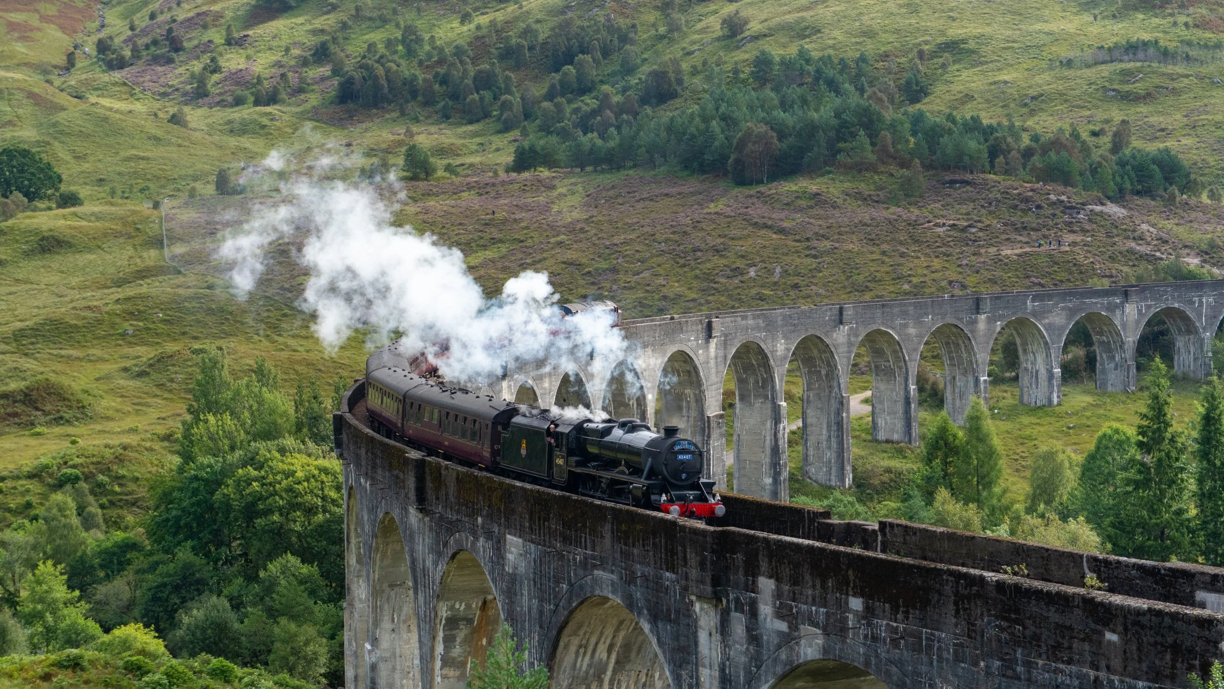 Jacobite Steam Train, Glenfinnan Viaduct, Scottish Highlands. The iconic Hogwart's Express crossing the glenfinnan viaduct. Campervan hire Scotland