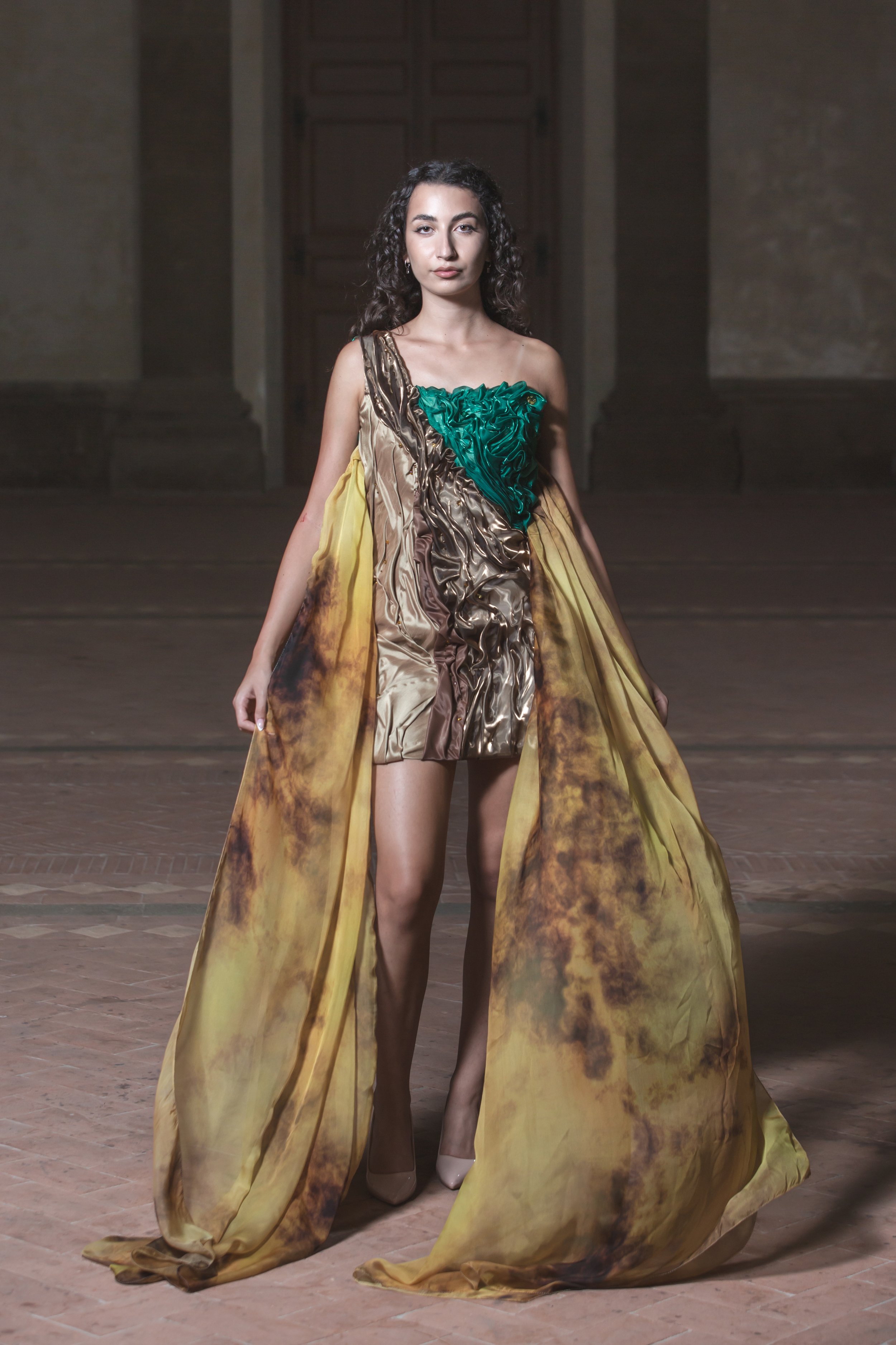 Presentato per la prima volta a DETTO FATTO su Rai2 nel 2016 il tubino è costituito da drappeggi realizzati con shantung marrone chiaro, organza marrone cangiante e verde cangiante. 
Con questi colori e forme ho voluto rappresentare la terra, l’eleme