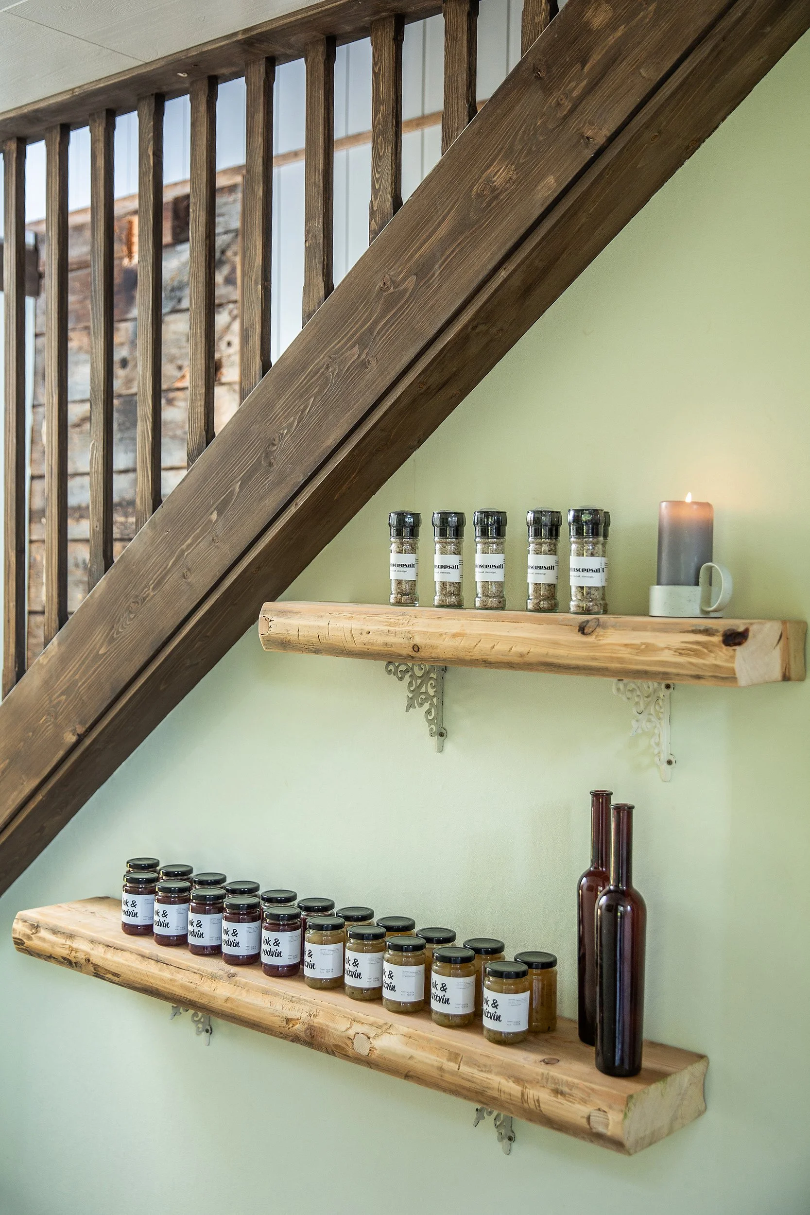 Krydderglass på en hylle med stearinlys.