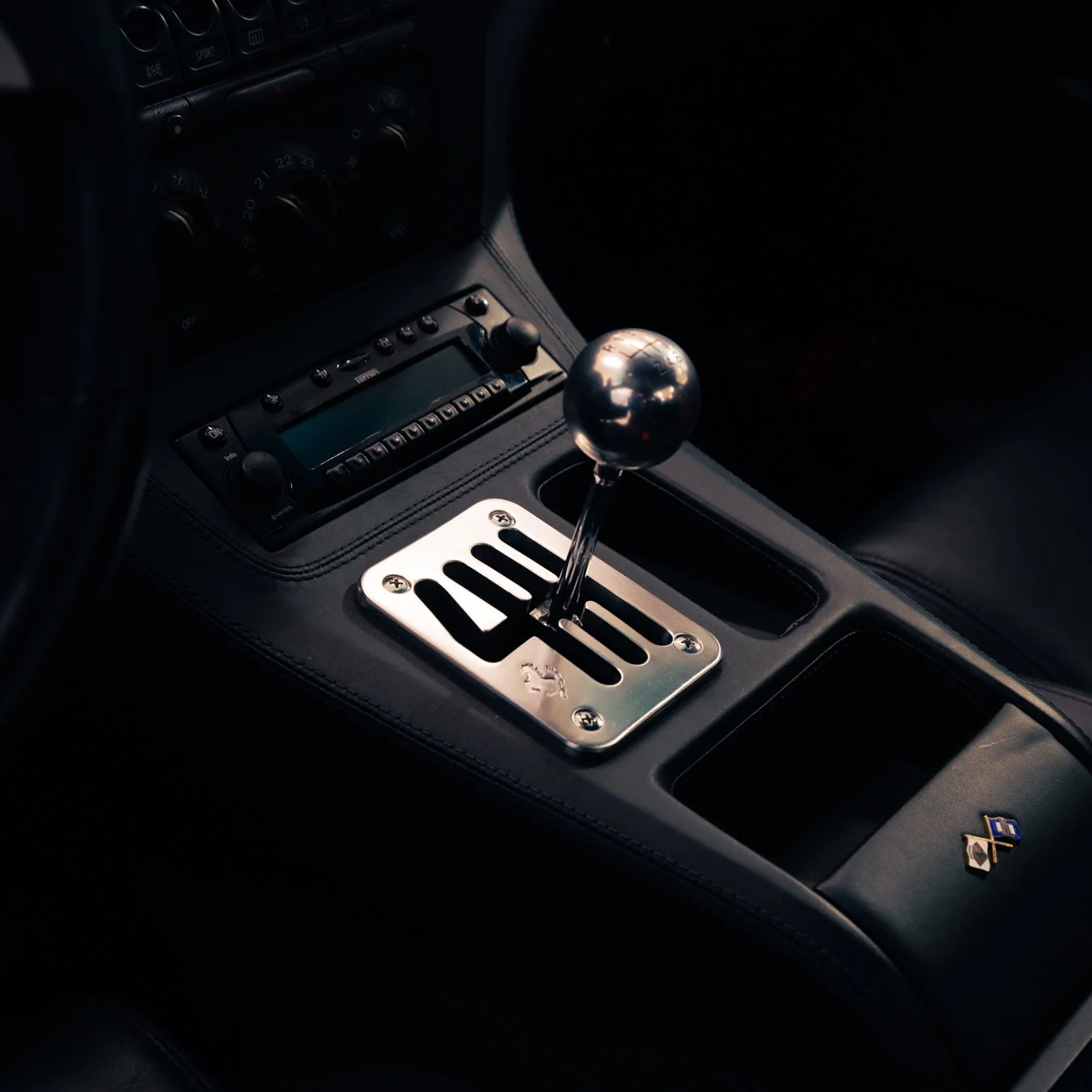 Close-up of a car gear lever and centre console.