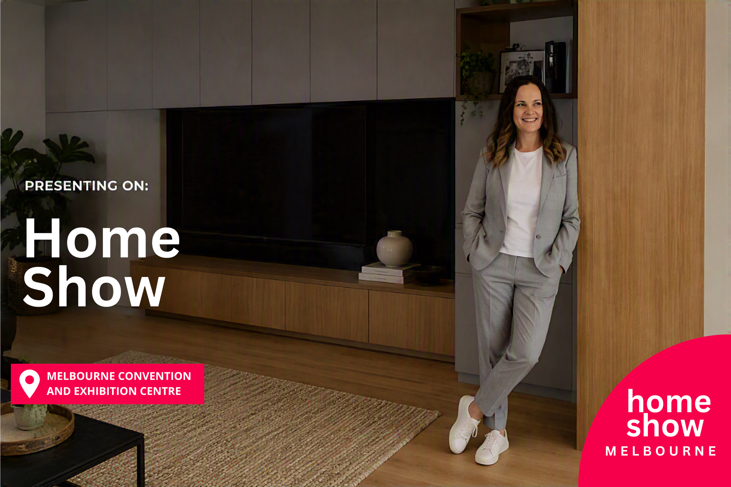 A woman in a light gray suit and white sneakers standing in a modern living room with a big black TV, wooden and gray cabinets, potted plants, and a colorful rug. Text overlay promotes a home show at the Melbourne Convention and Exhibition Centre.
