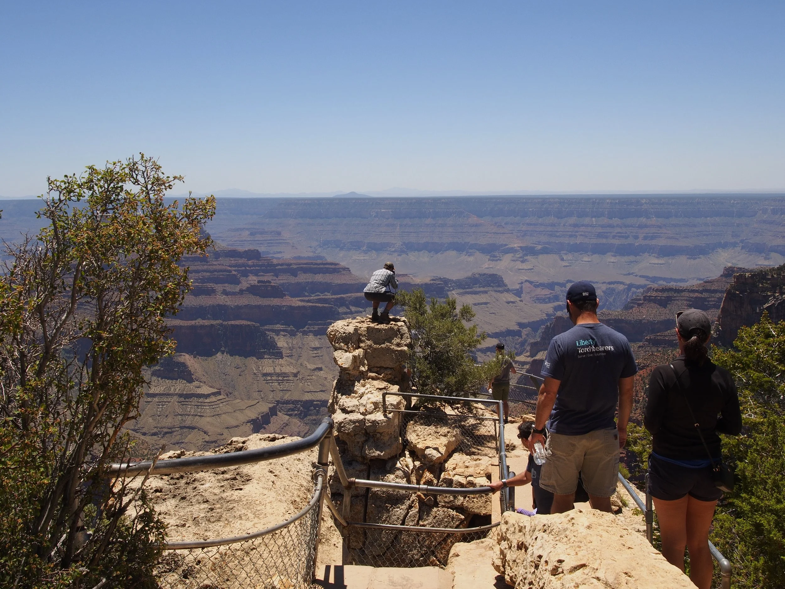 That's him, standing precariously on a cliff's edge of the Grand Canyon, trying to get a better angle.
