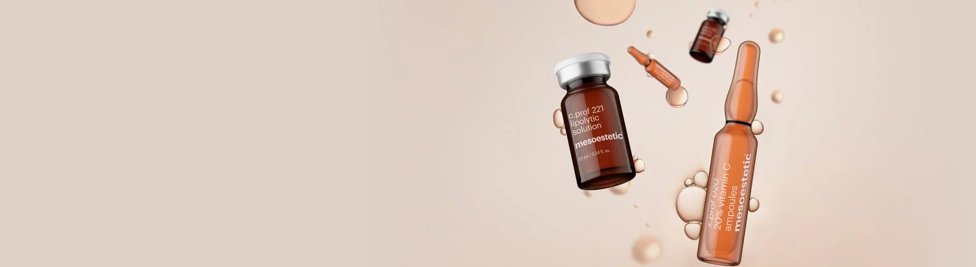 Cosmetic skincare products in brown bottles floating with liquid droplets against a beige background.