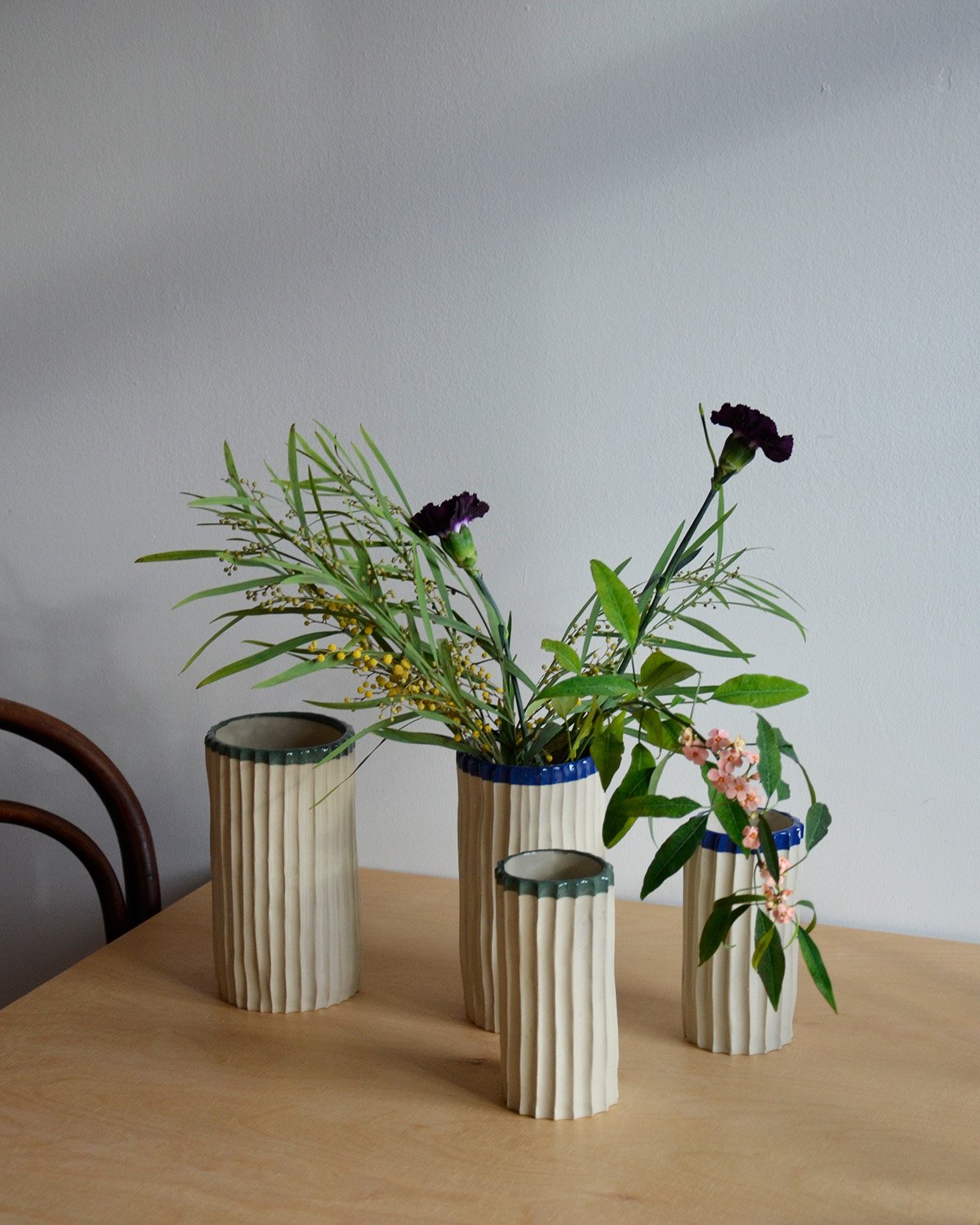 Collection of handbuilt ceramic vases in two sizes with bold green and blue rims—perfect for floral arrangements or as versatile decorative pieces for any space.