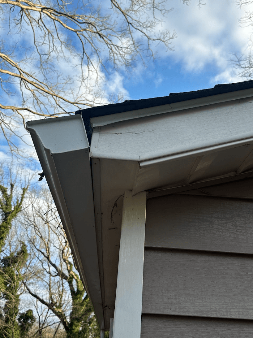 Close-up of a detached gutter pulling away from the roof edge and fascia, showing separation that can lead to water damage in Chattanooga, Tennessee