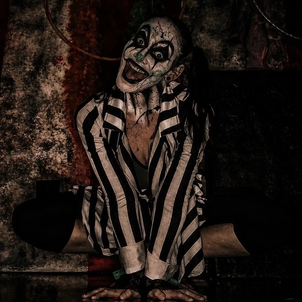 Dark haunt actor in darken haunted attraction set posing for camera
