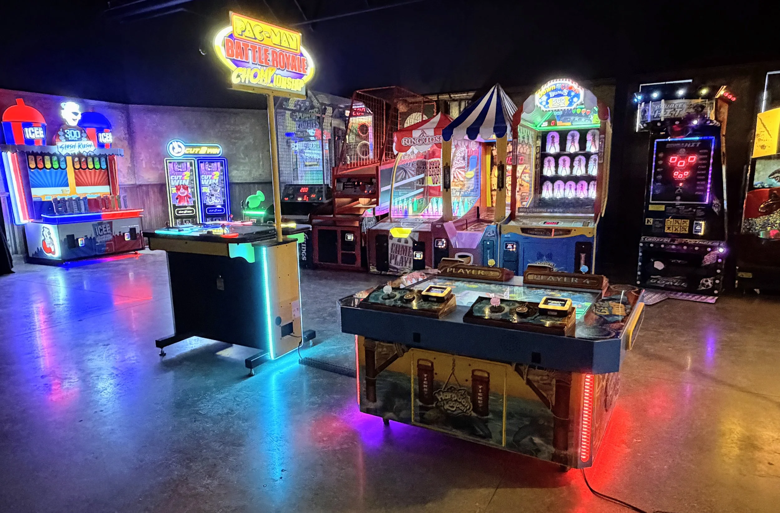 Neon colors and lighting in an arcade full of games with names like PacMan and more.