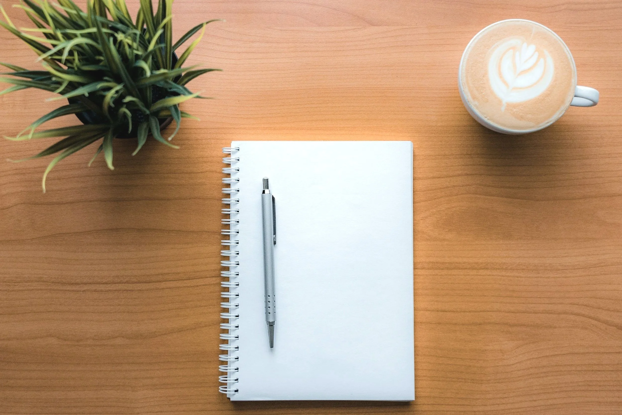 empty note page with pen, plant and cup