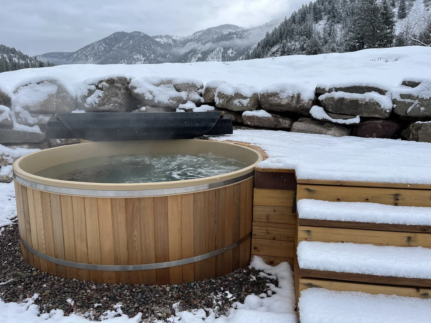 Hot tub paired with the Cedar Sense barrel sauna at Blackfoot River House
