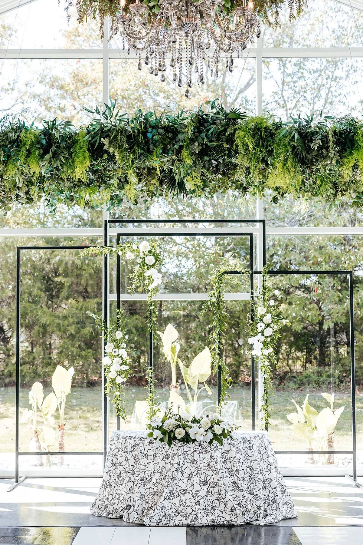 sweetheart-table-white-floral-linens-rectangel-arbor-with-flowers.JPG