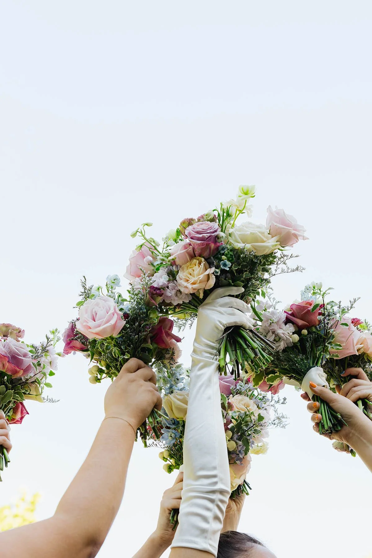 bride-bridesmaids-holding-bouquets-in-air-white-glove-blush-mauve-bouquets.JPG