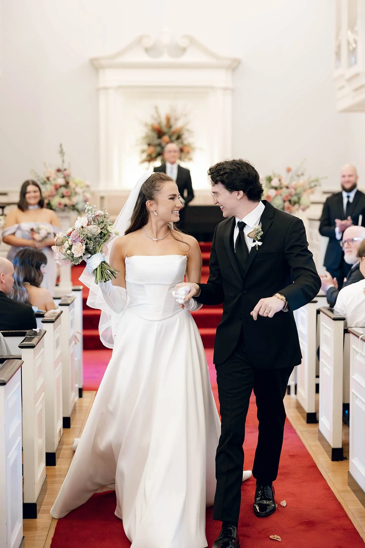 newlyweds-walk-down-aisle-national-ave-church.JPG