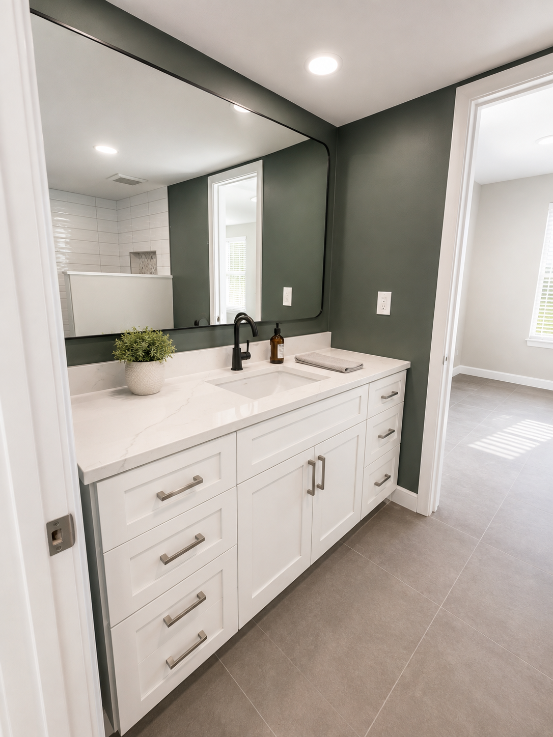 Beautifully renovated primary bedroom with walk in shower and ample storage. 
