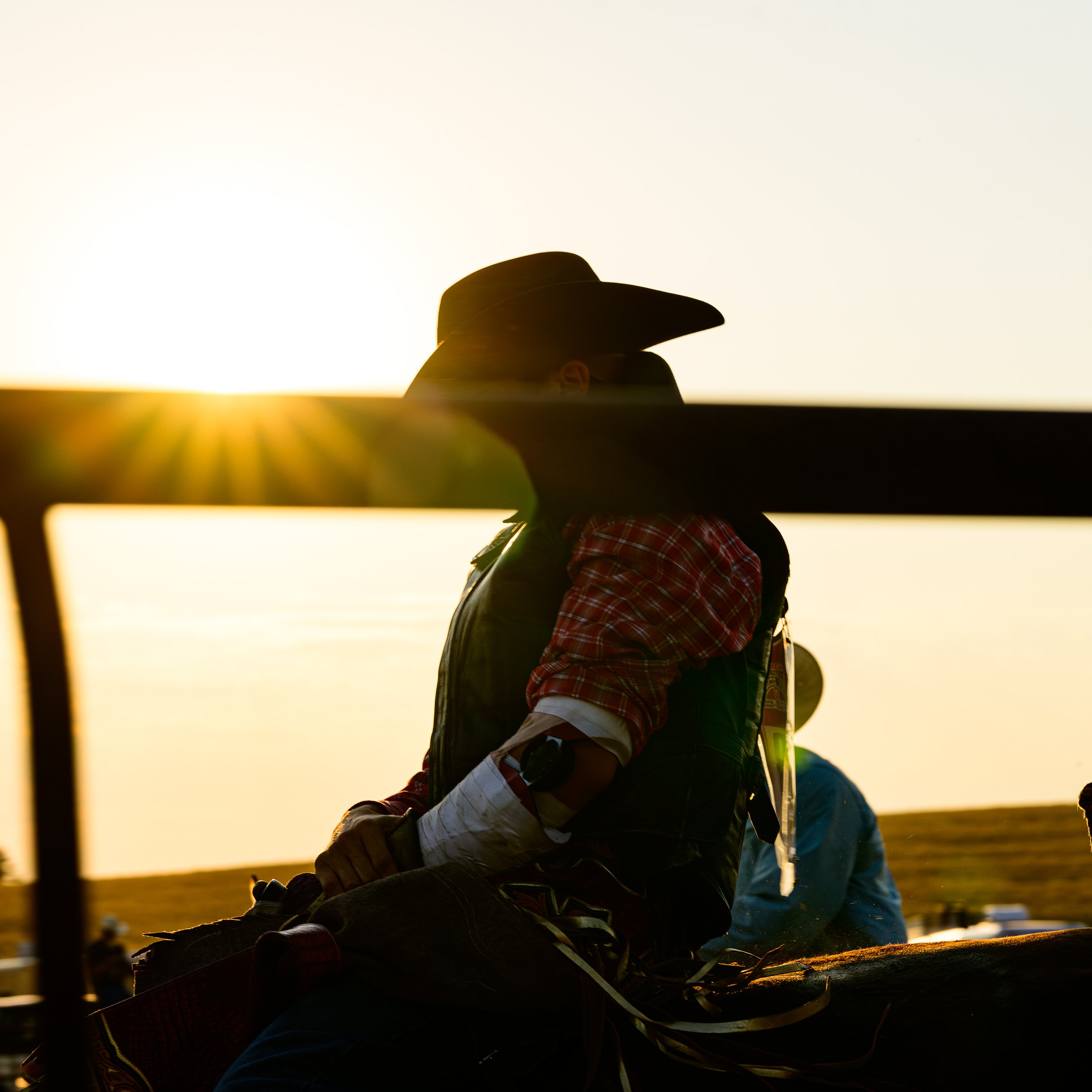 A bronc rider at sunset