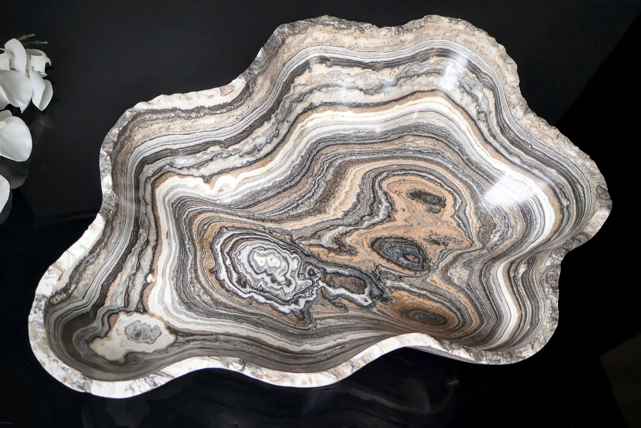 closeup of a zebra onyx bowl with black background