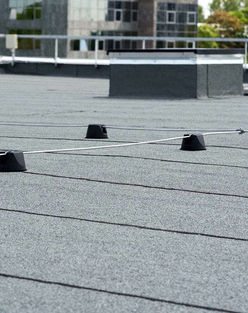 Flat commercial rooftop with cable anchors and safety lines