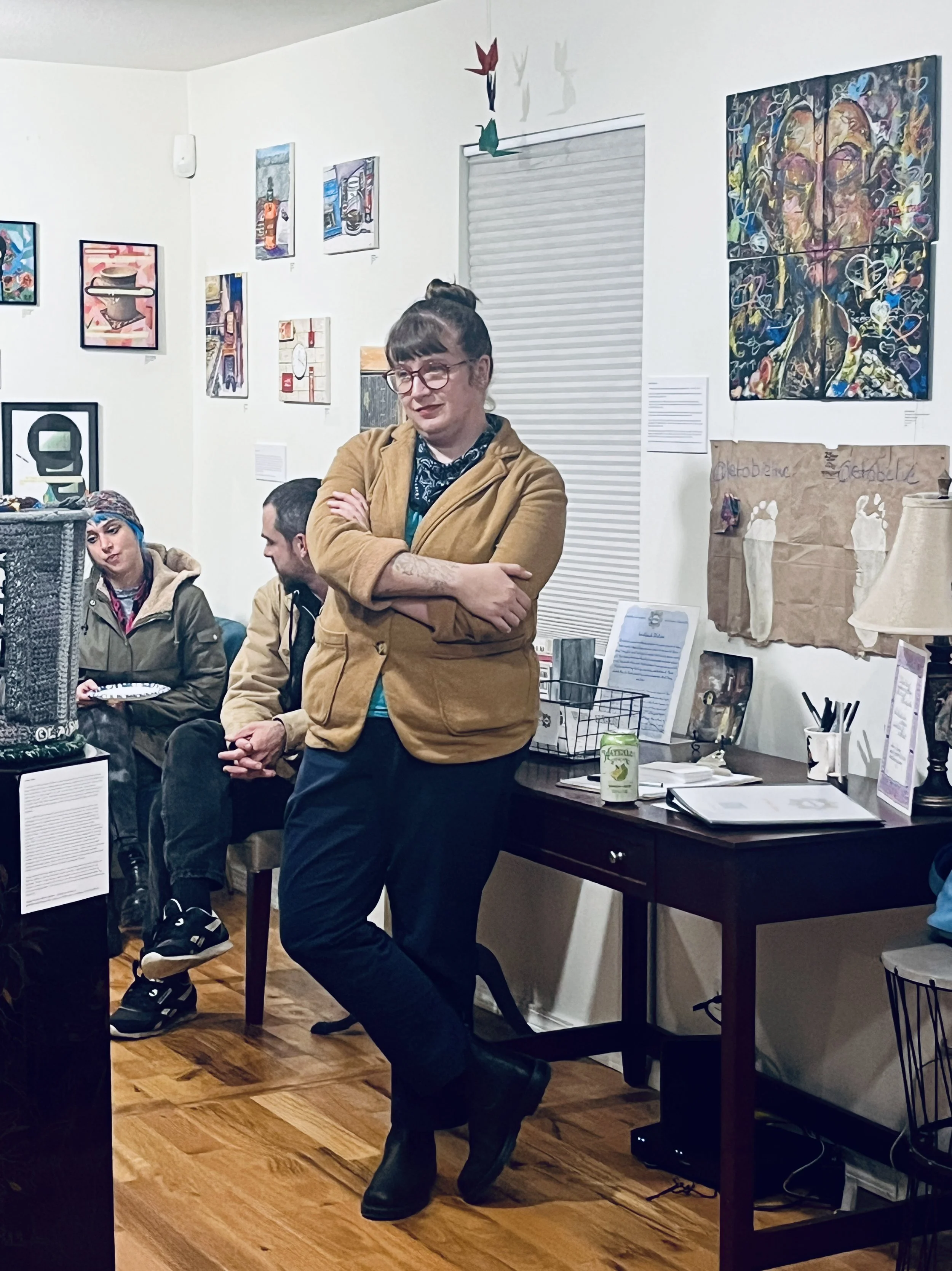 Artist Jamie Pierson in front of works by Obie Weathers