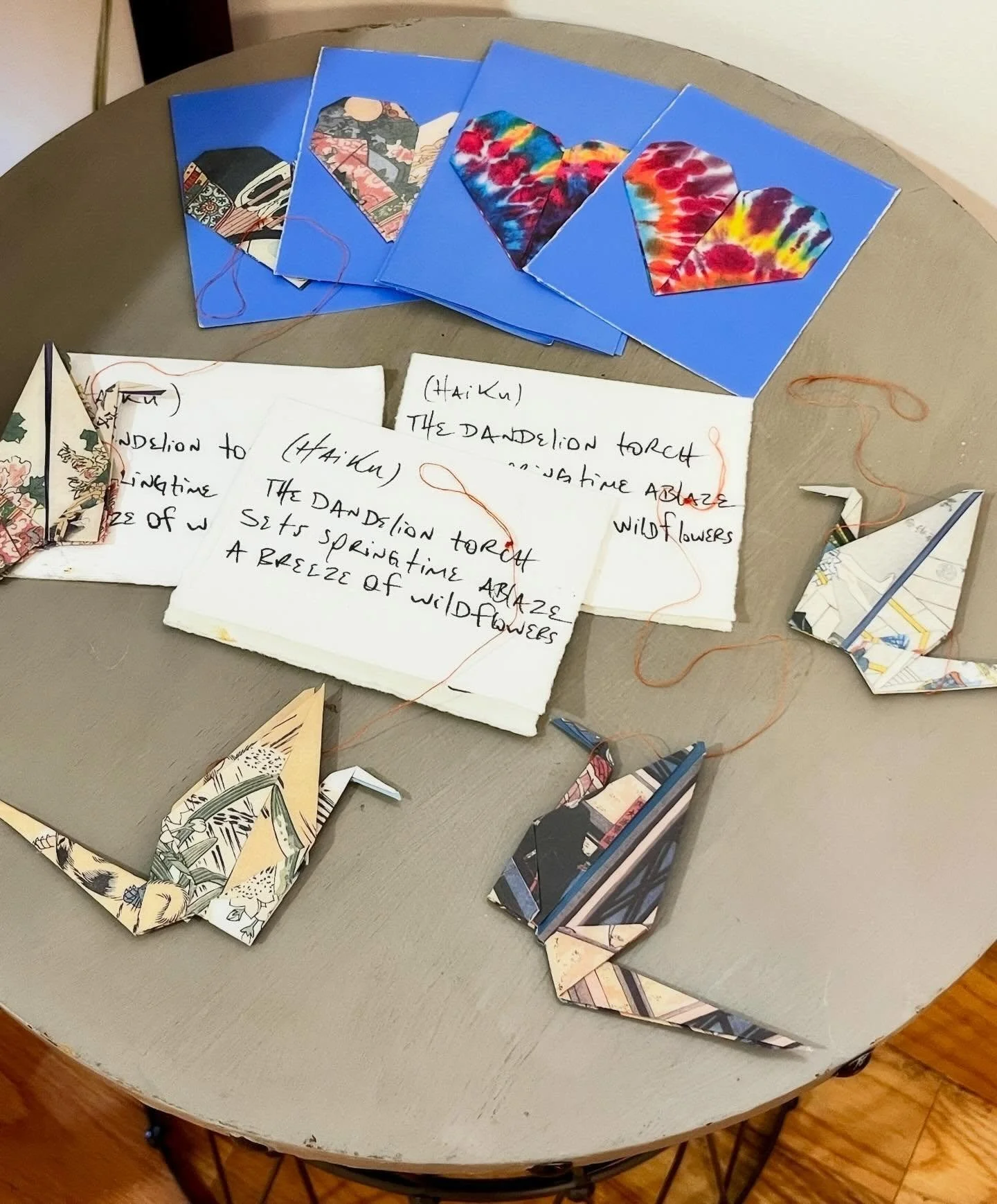 Our good friend @letobielive sent these handmade thank you gifts for visitors to JustArts. Stop in to see our collection, spend some time (and maybe even some money 😉), and take one of his cranes, cards, or springtime haiku home with you. 💚🦋🪺🌱☀️