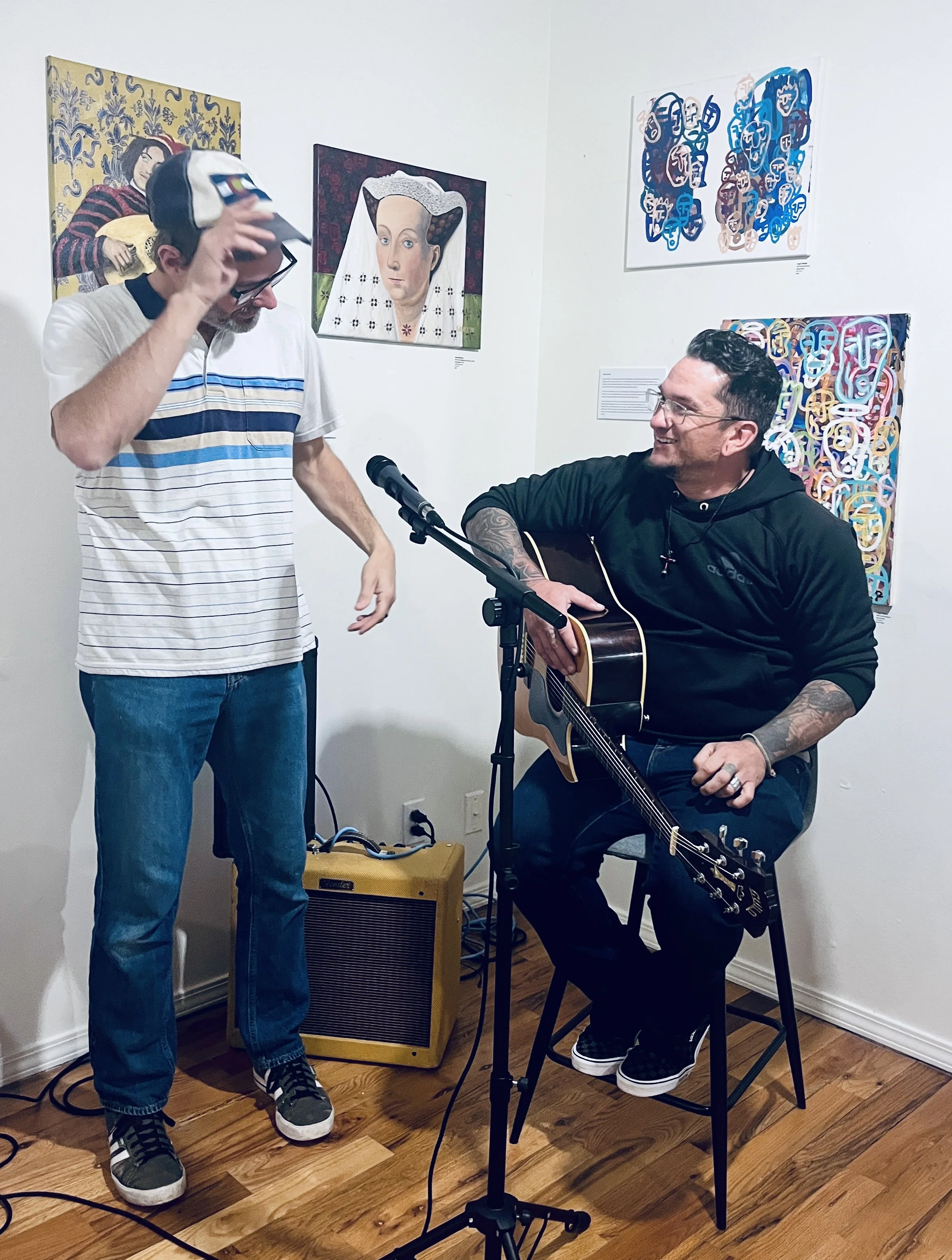 Neon Squid about to perform in front of works by Sam Anderson (L) and Angel Okolie (R)