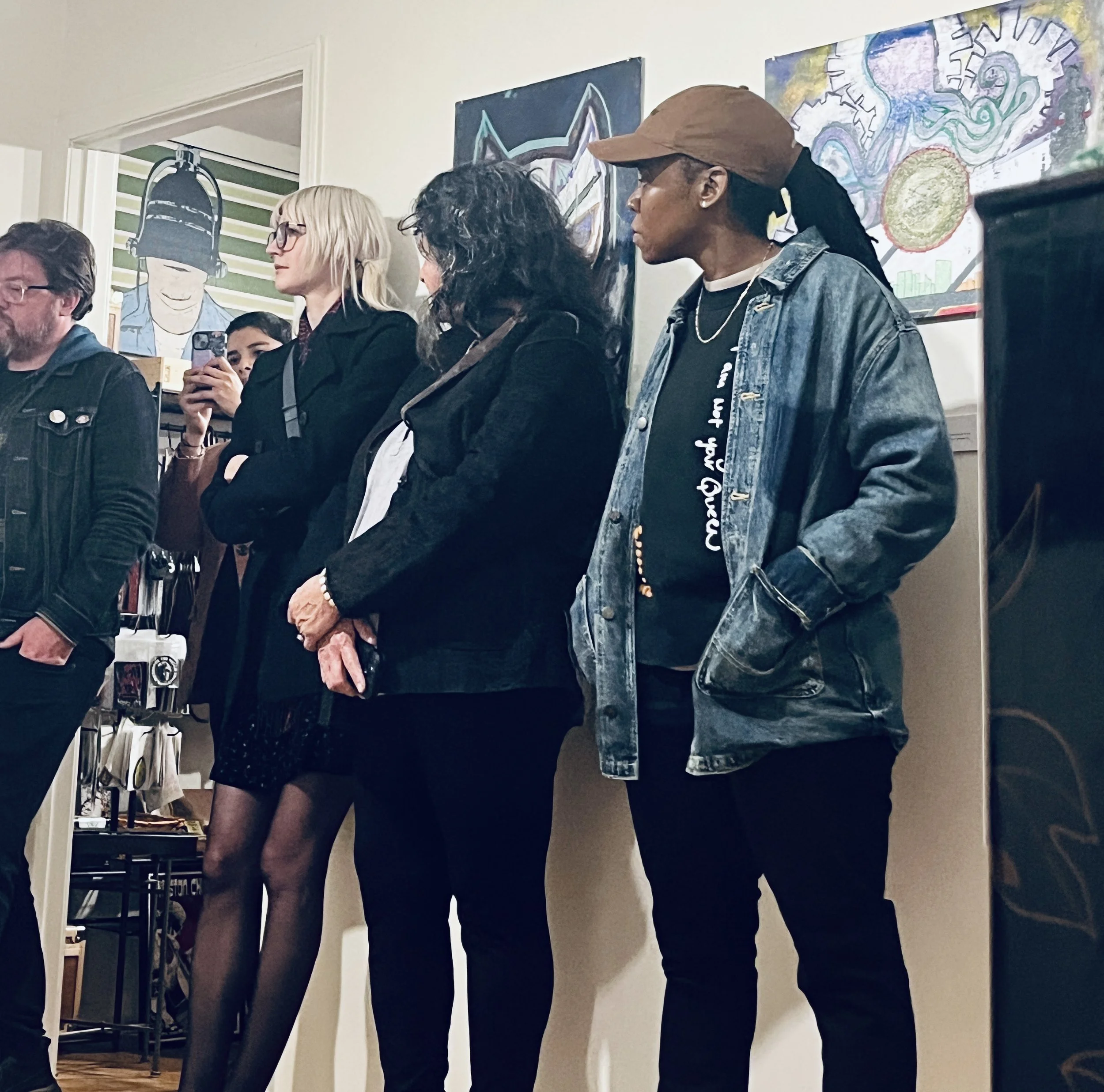 Guests in front of works by Neon Squid