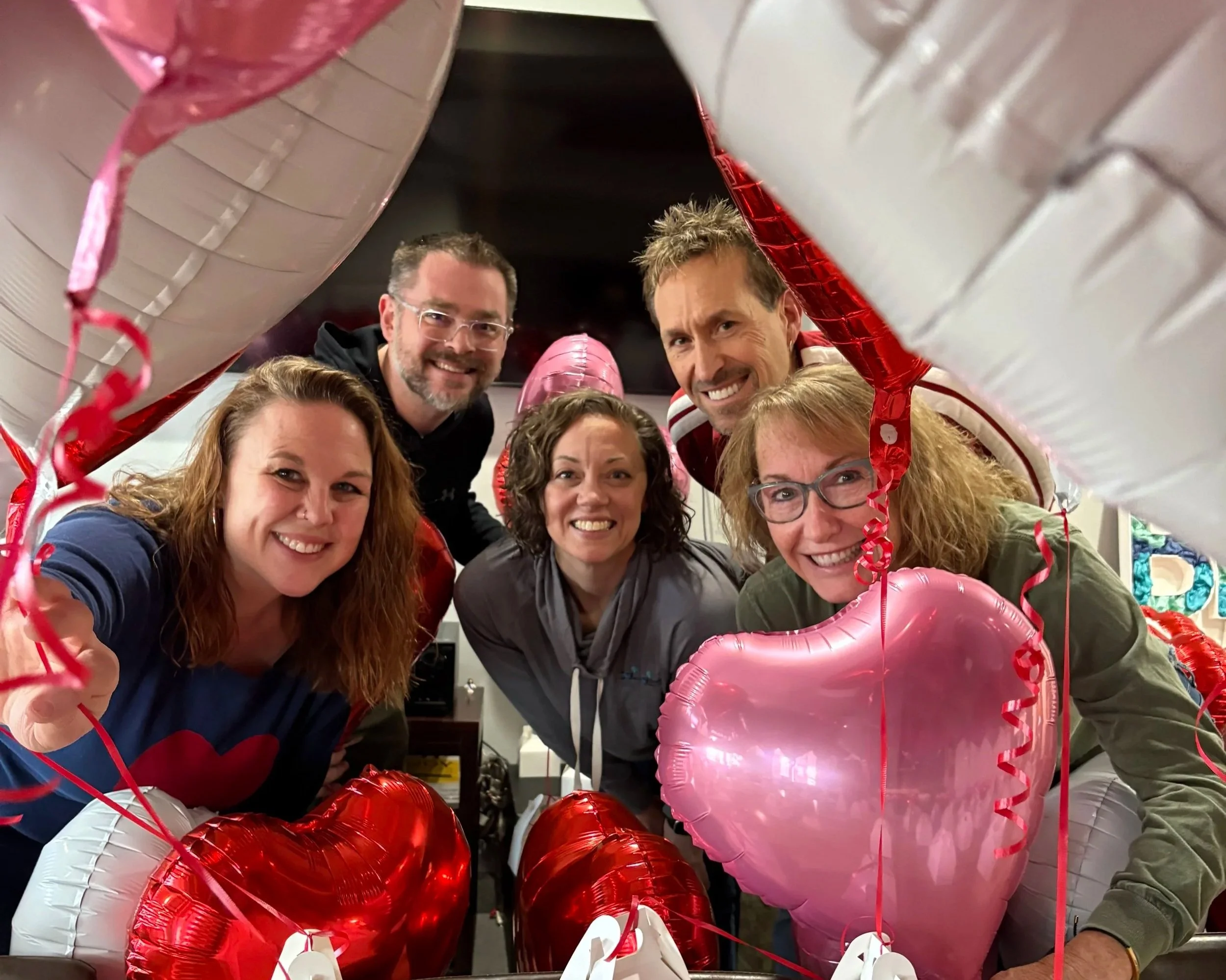 Tommy and Brooke, Elsie, and Jeremy and Amanda surrounded by balloons