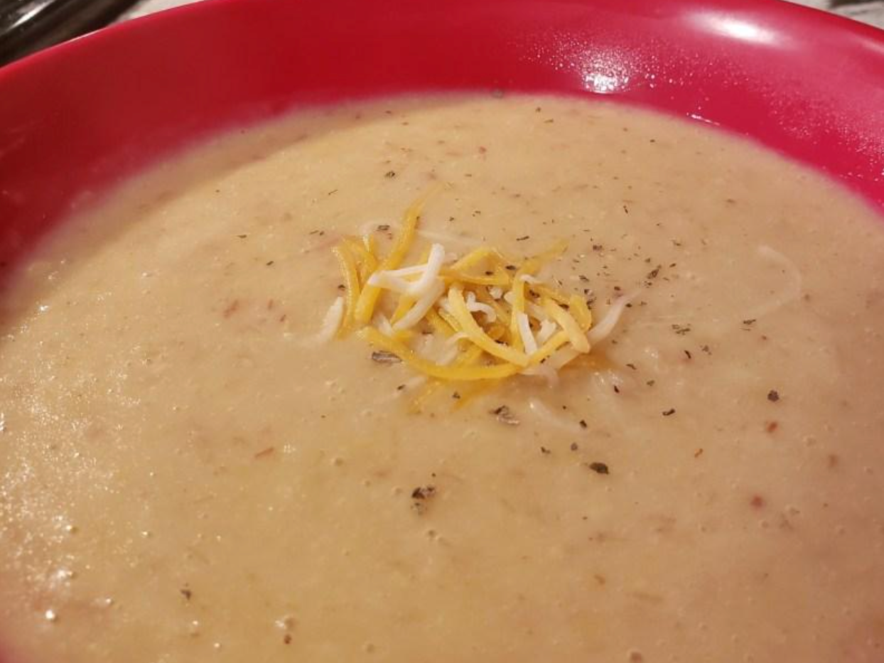 Cheese topping on bowl of corn chowder