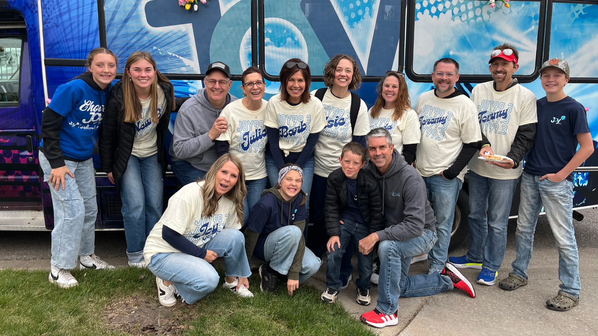 Joy99 team in front of the JoyBus