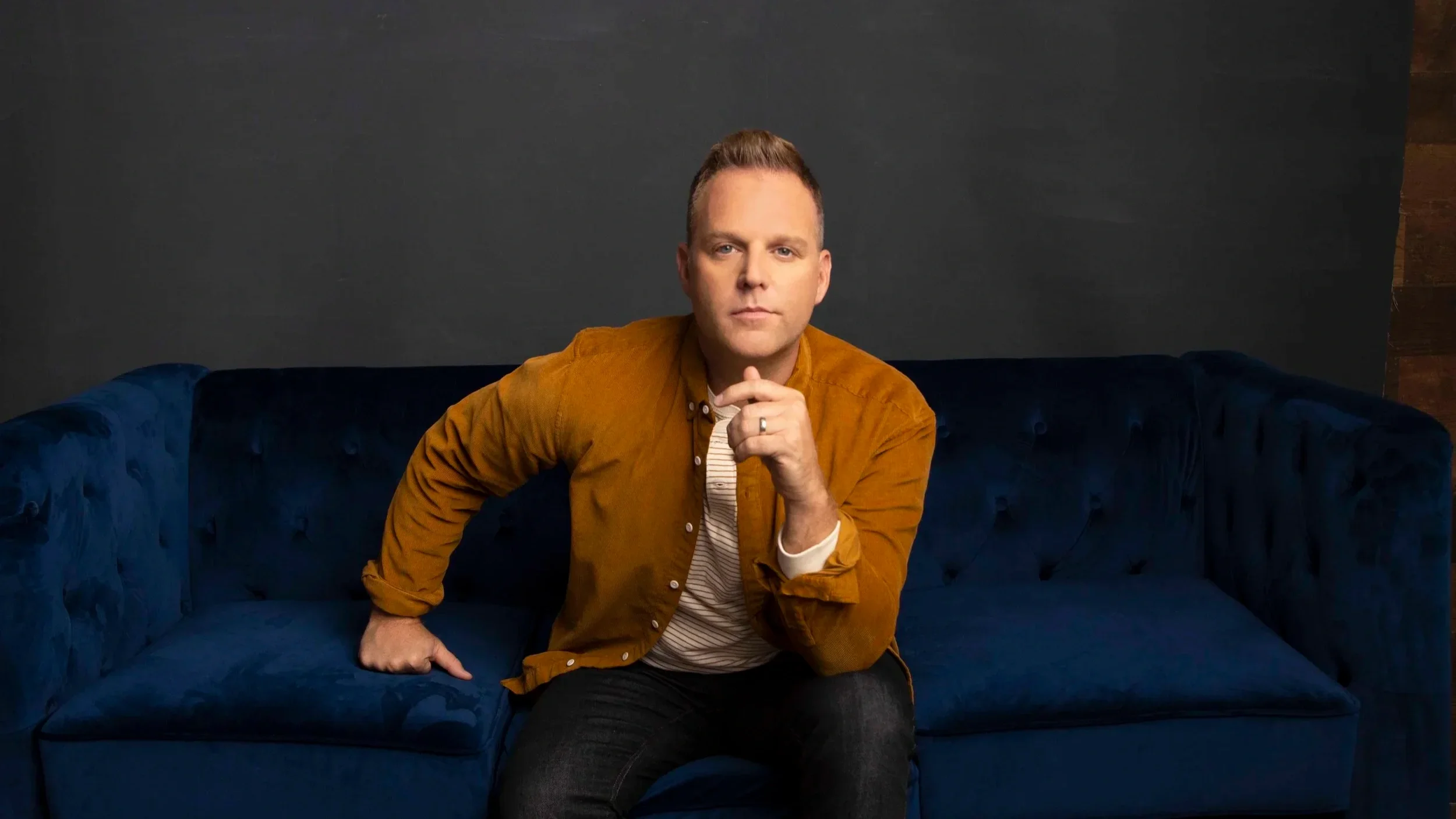 Matthew West sitting on a blue couch