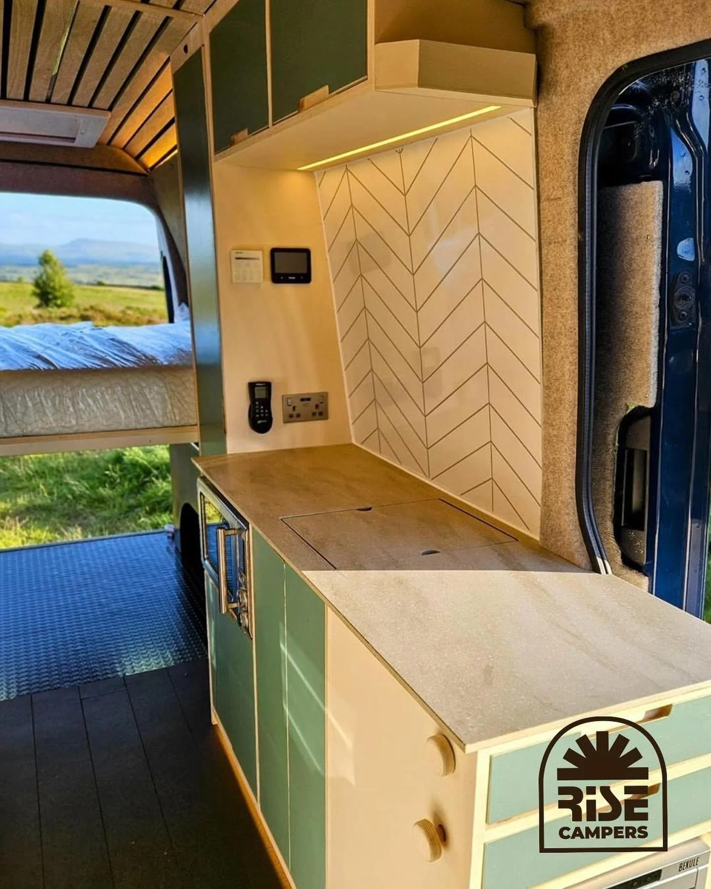 Huge kitchen in this one! Underslung sink &amp; tap to maximise use on the @coriandesign worktop. Handcrafted using lightweight poplar ply. Integrated handles, exposed edges and a unique cocktail table on the rear giving this van a one of a kind feel